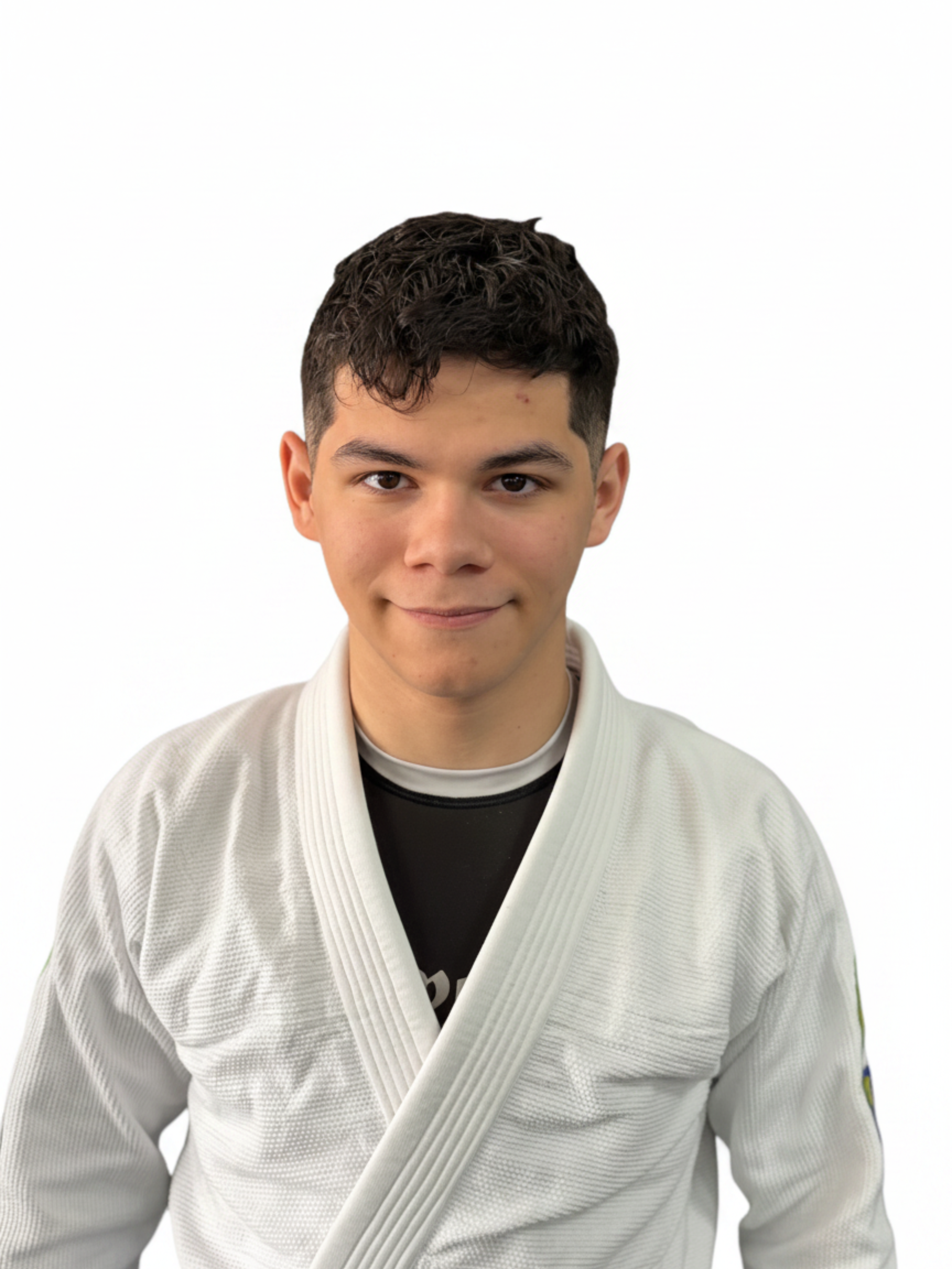 Young man wearing a white martial arts gi with a black T-shirt underneath, smiling against a white background.