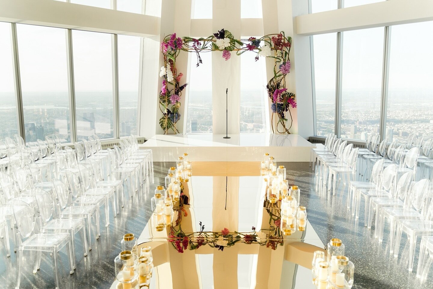 A brightly colored arch, mirrored aisle and ghost chairs fit this space perfectly to fully take in the breahtaking views on top of the world!⁠😍🌆
.⁠
We are back at 👏🏻ASPIRE 👏🏻tomorrow for a corporate site visit!! We are beyond excited to be a pa