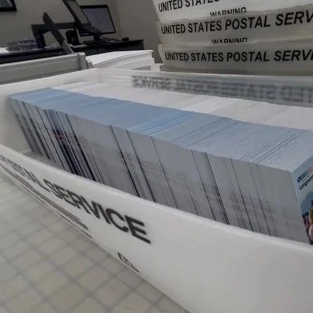 A stack of United States Postal Service bulk mail.