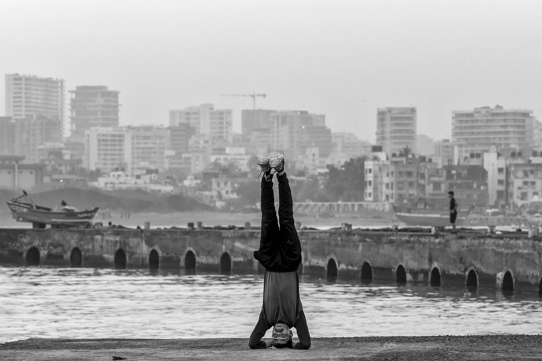 Man performing a headstand near Juhu Beach, Mumbai.