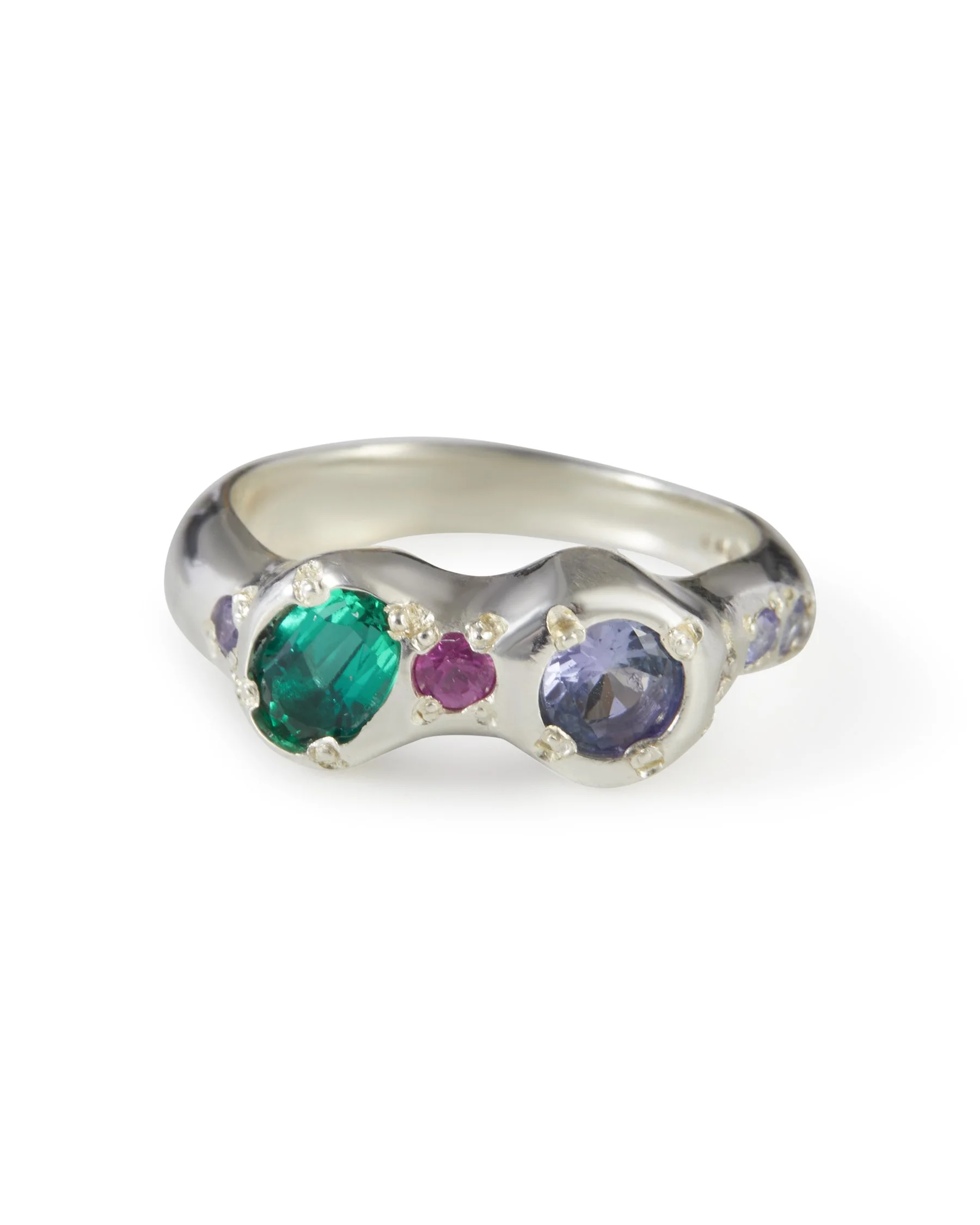 Jester Alien Eyes Ring in sterling silver with purple sapphire, pink sapphire, tanzanite and lab grown emerald gemstones.