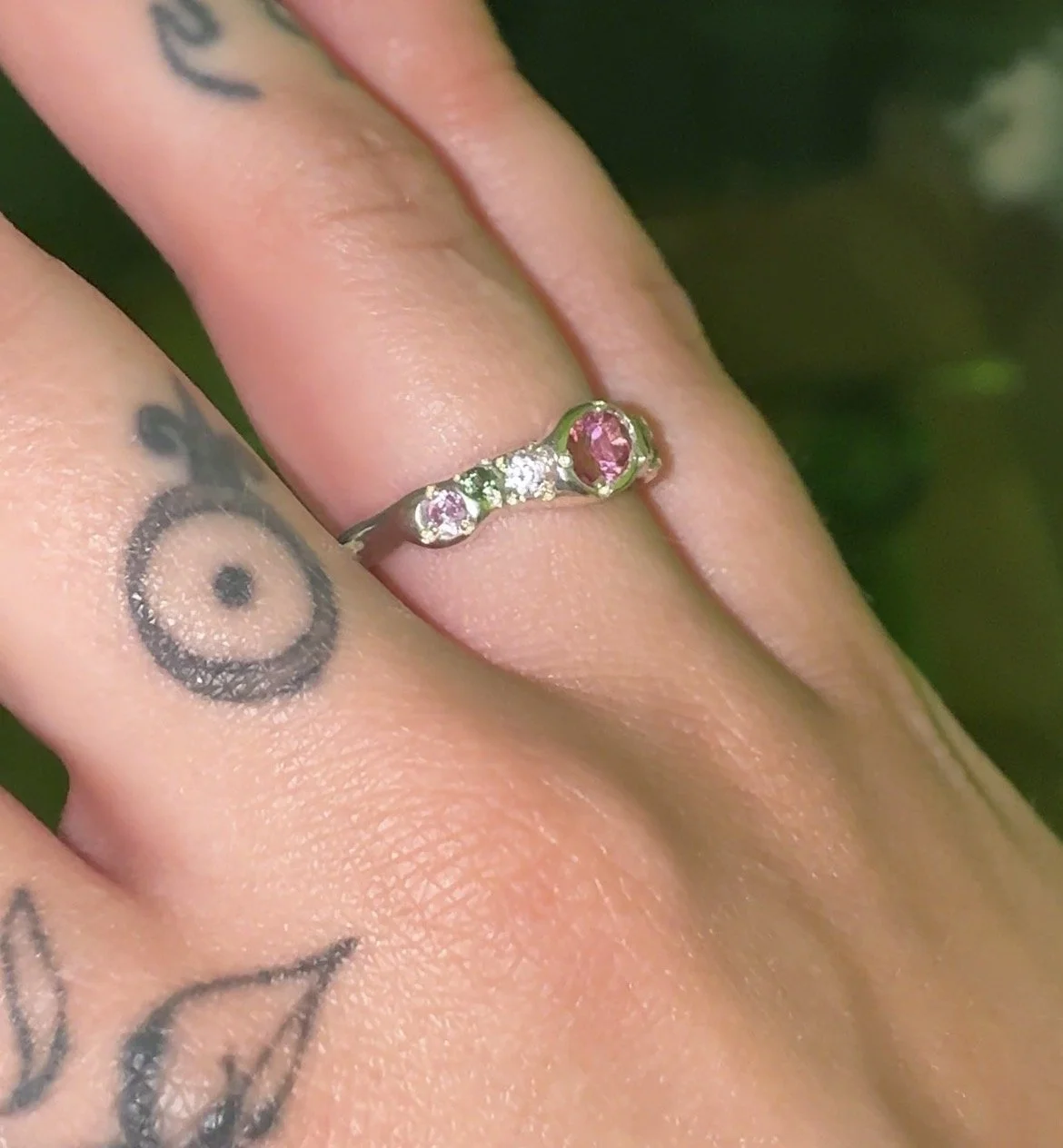 Venus silver band - a silver molten band with pink and green stones inspired by venus