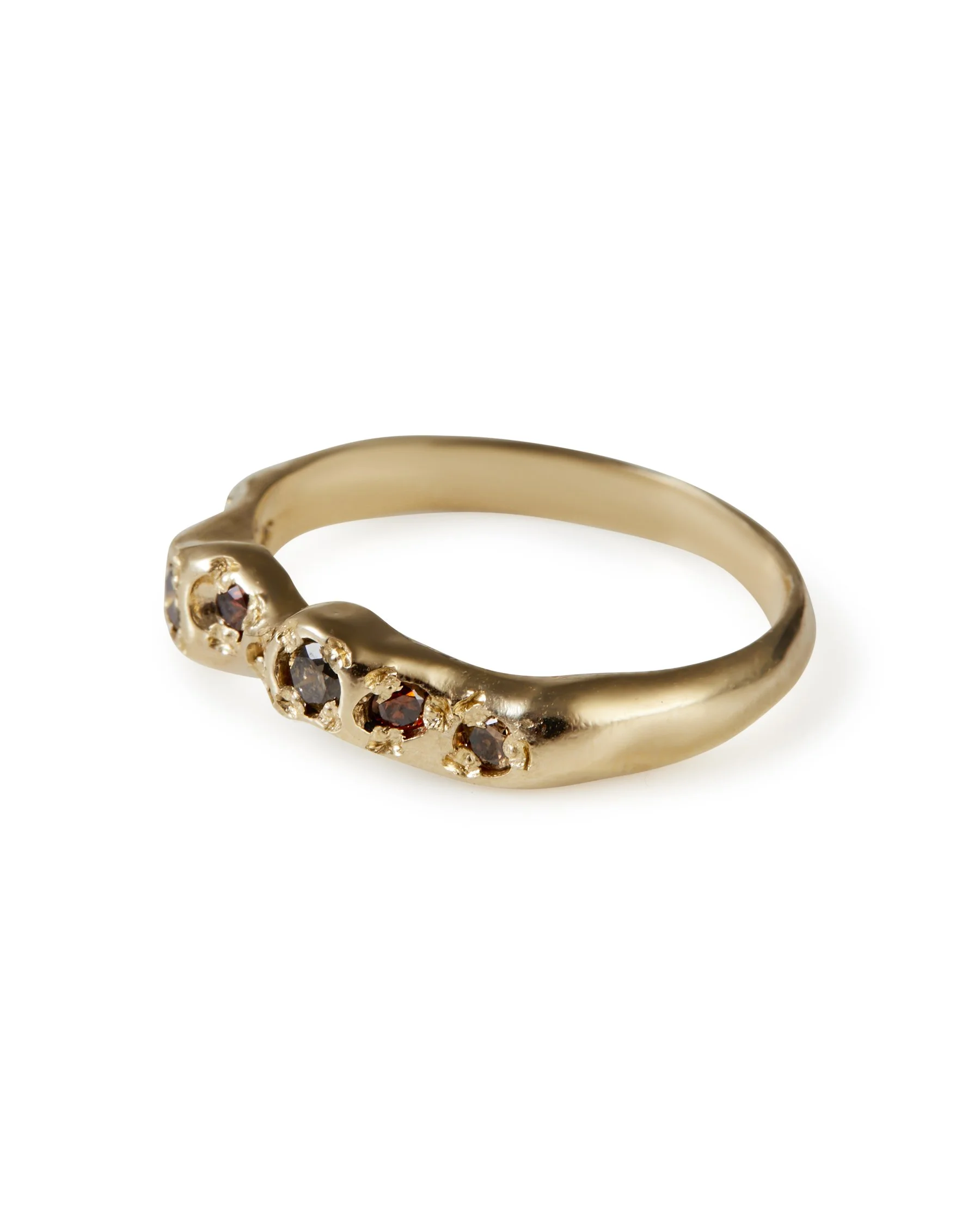 A molten gold ring with a line of blue diamonds set into it - side view