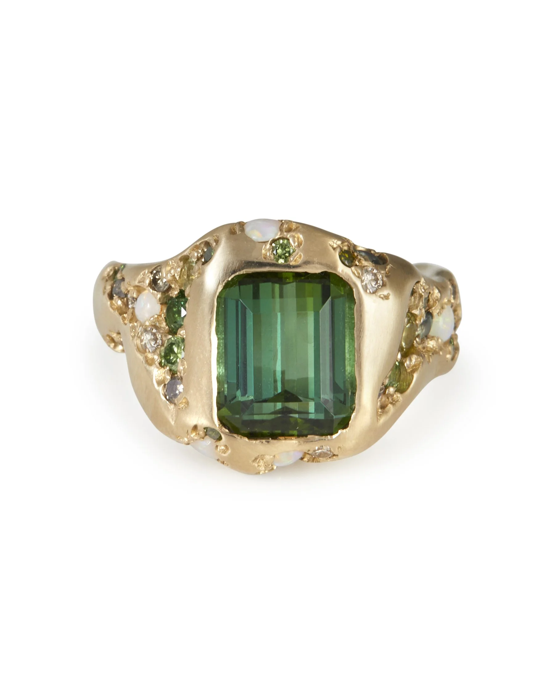A large green stone ring with intricate green side stone details in molten gold