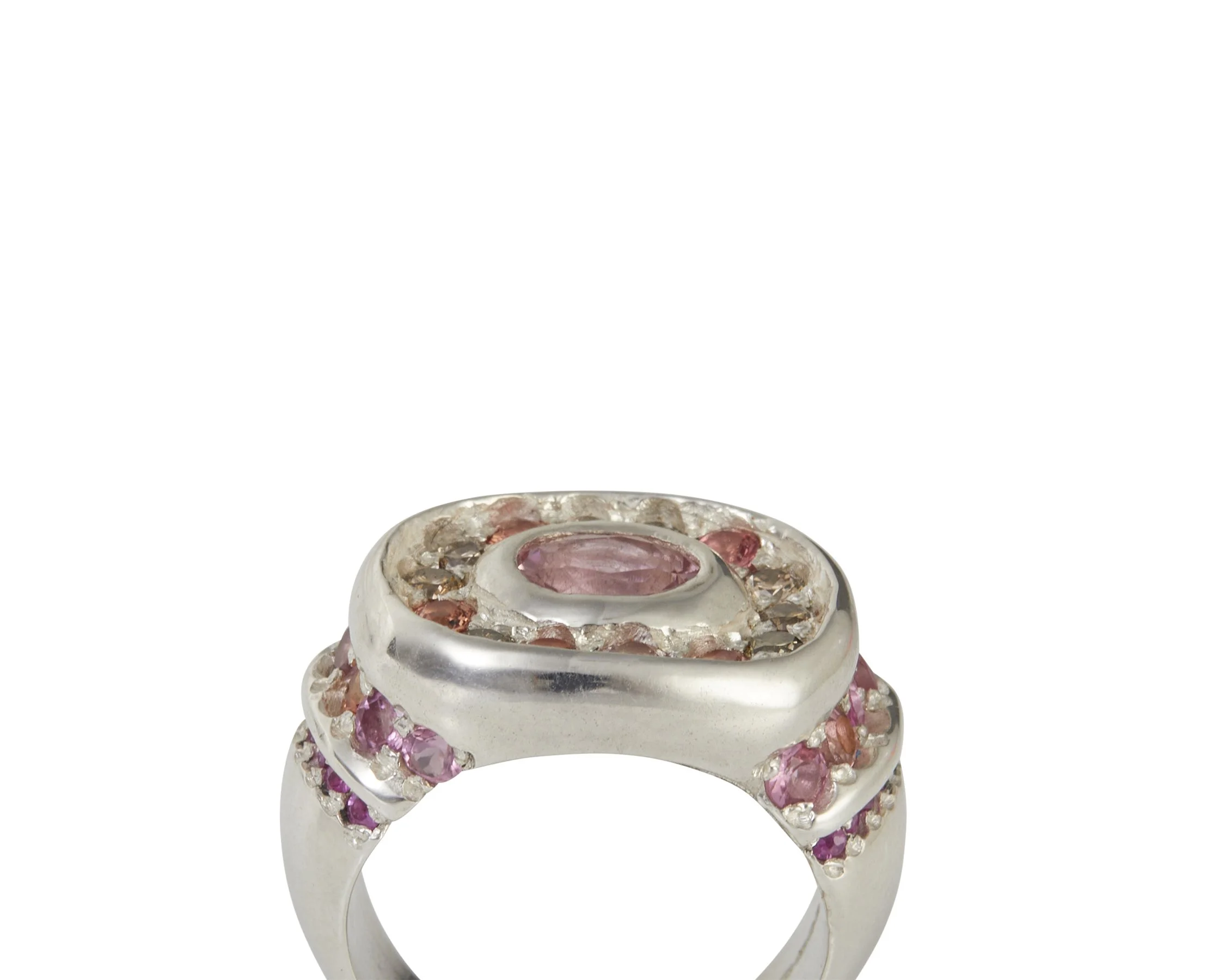A large silver ring with brown and pink gemstones and orange side stones