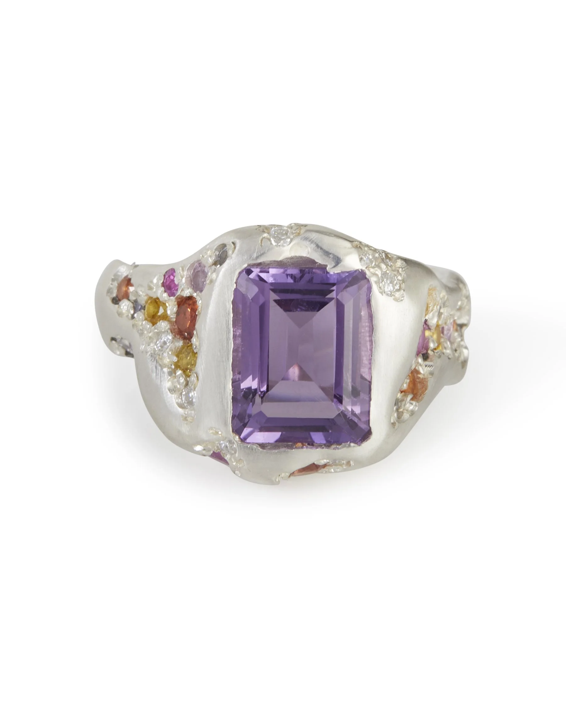 A big silver ring with a rectangular amethyst in the centre and sides stones of pinks oranges and yellows