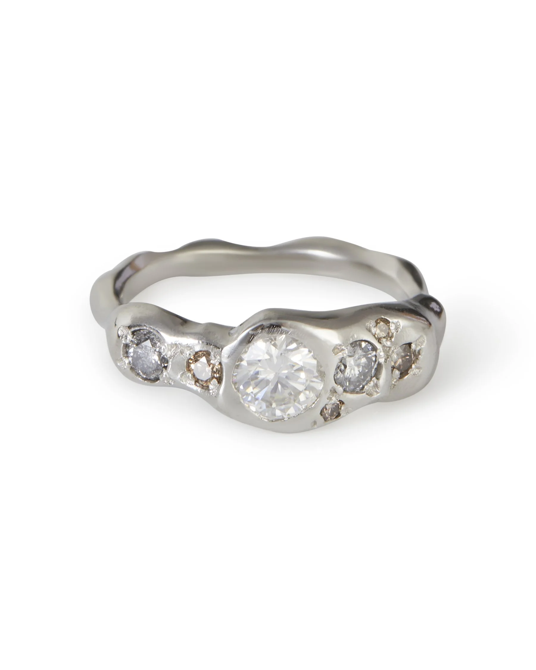 A platinum ring with white grey and brown stones - molten
