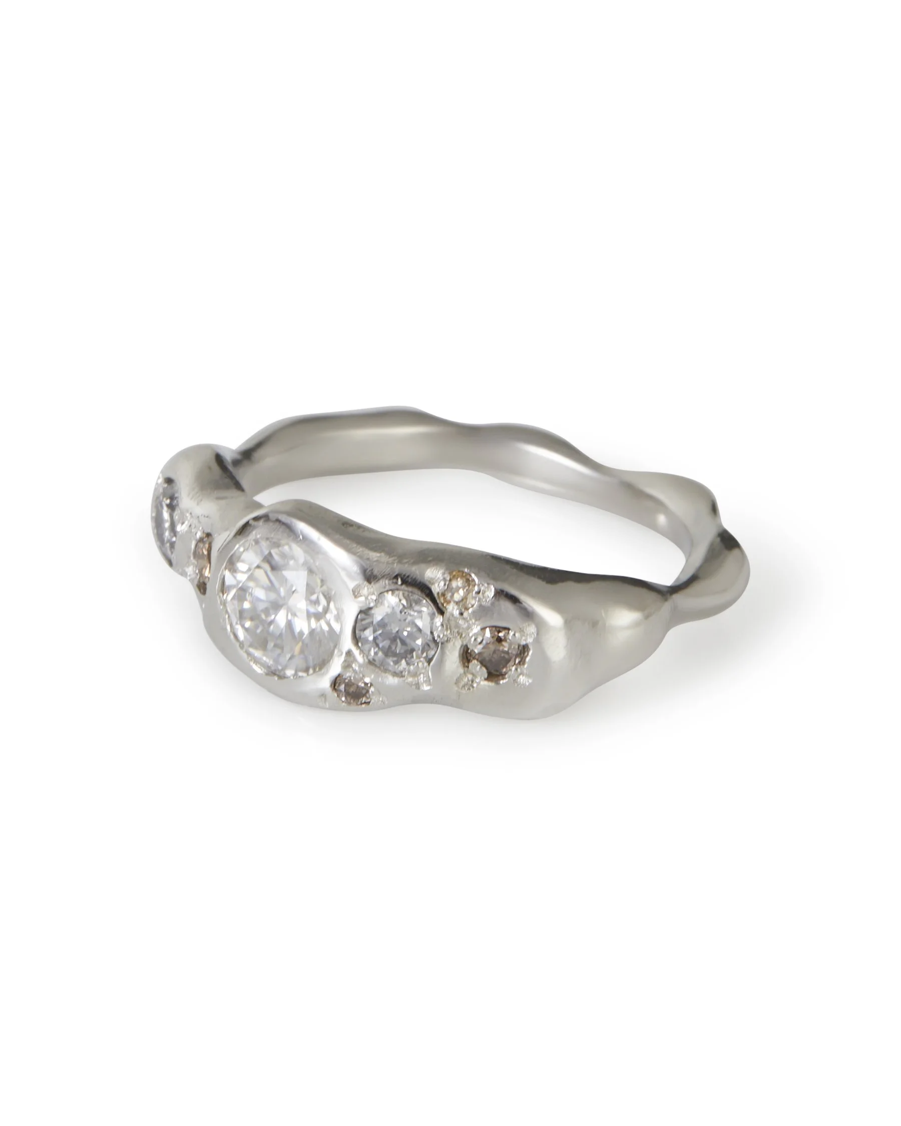 A platinum ring with white grey and brown stones - molten