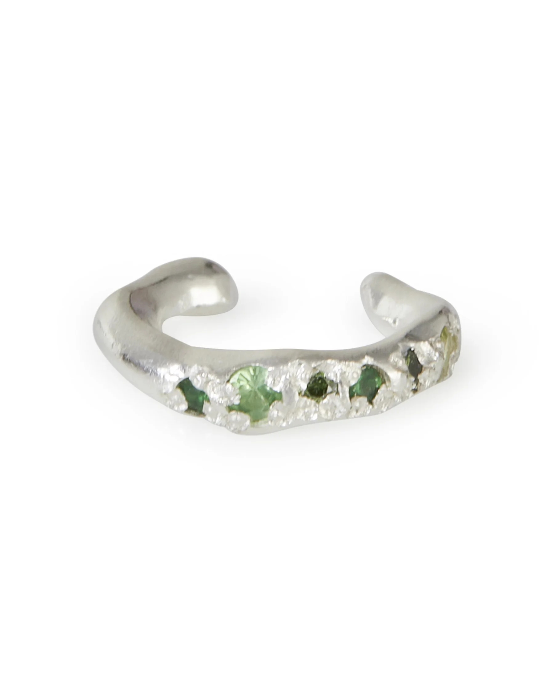 A molten ear cuff with green stones on a white background