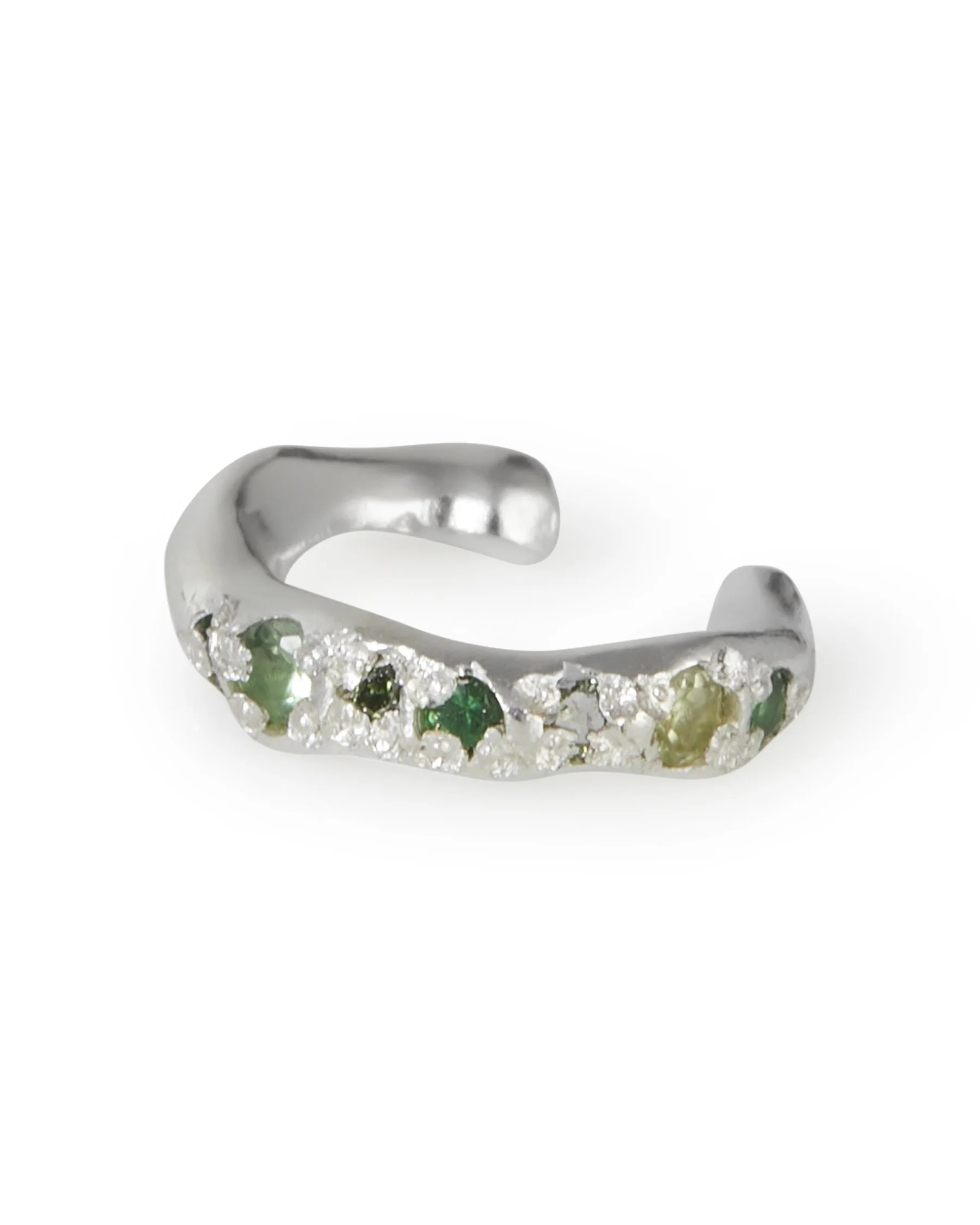 A molten ear cuff with green stones on a white background