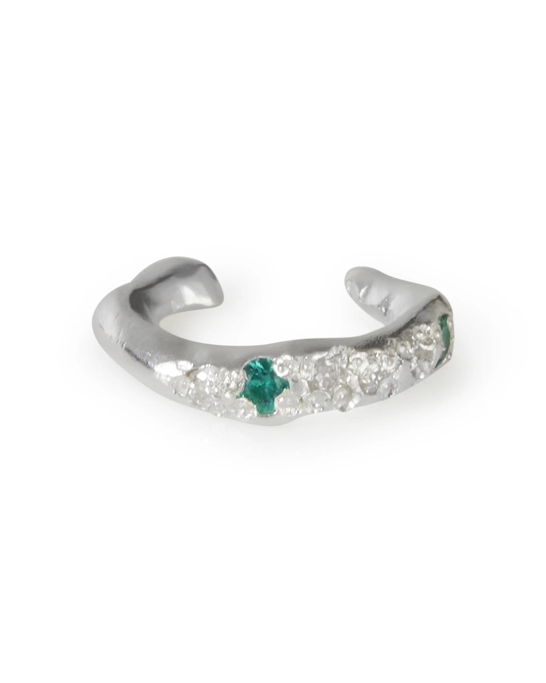 A molten ear cuff with green and white stones on a white background