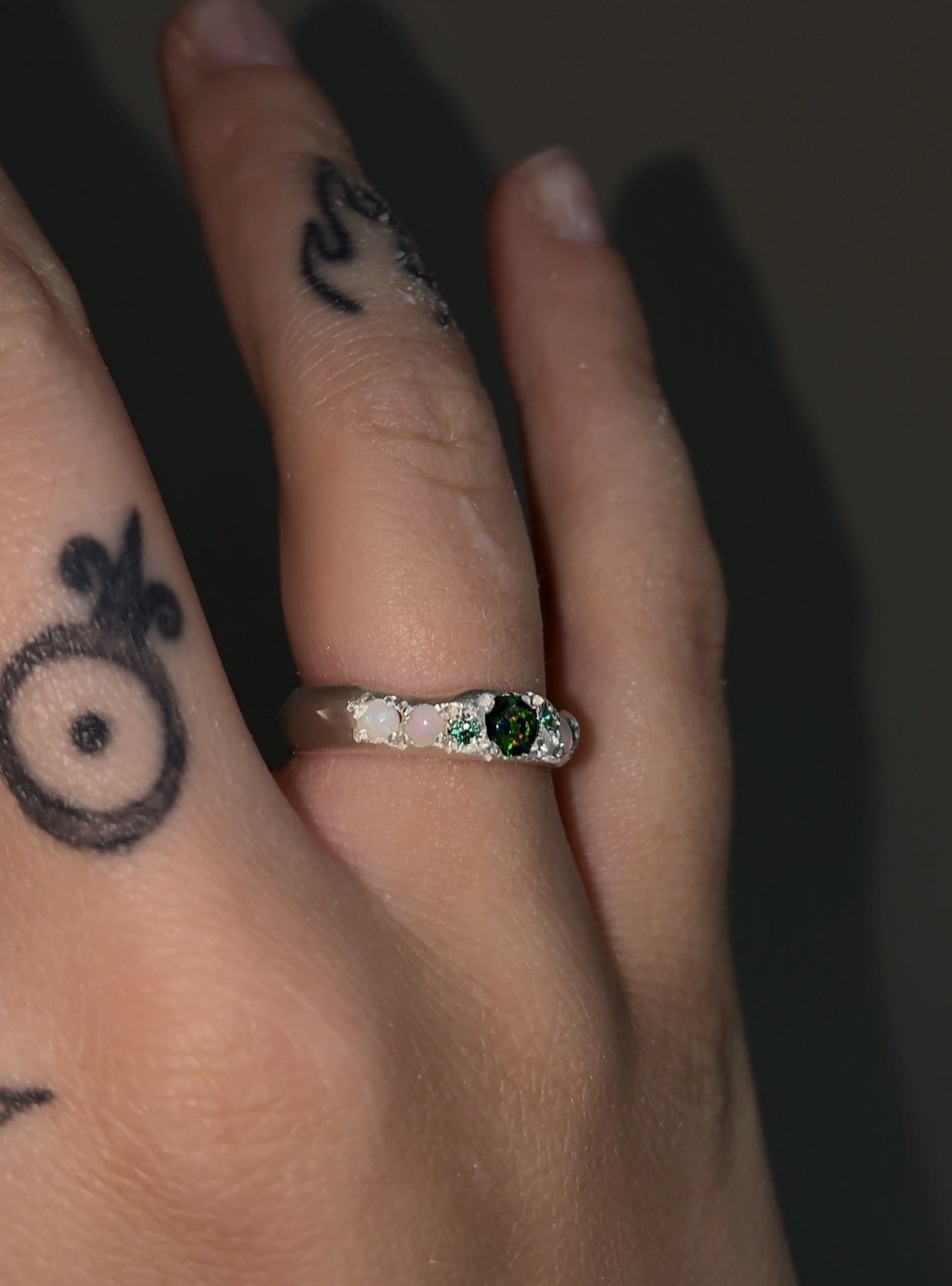 A Molten silver band with synthetic opal, white opal and synthetic emerald