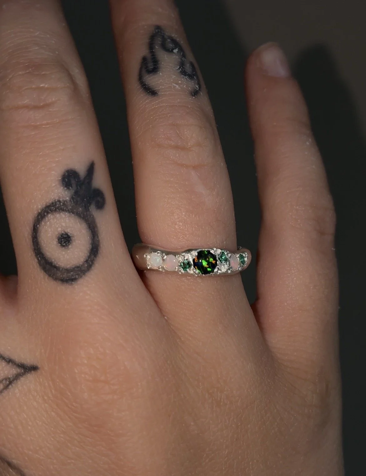 A Molten silver band with synthetic opal, white opal and synthetic emerald
