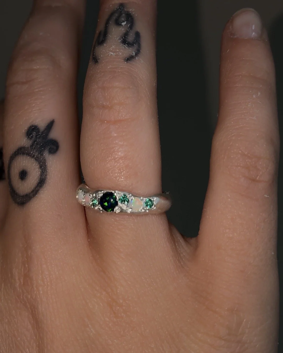 A Molten silver band with synthetic opal, white opal and synthetic emerald