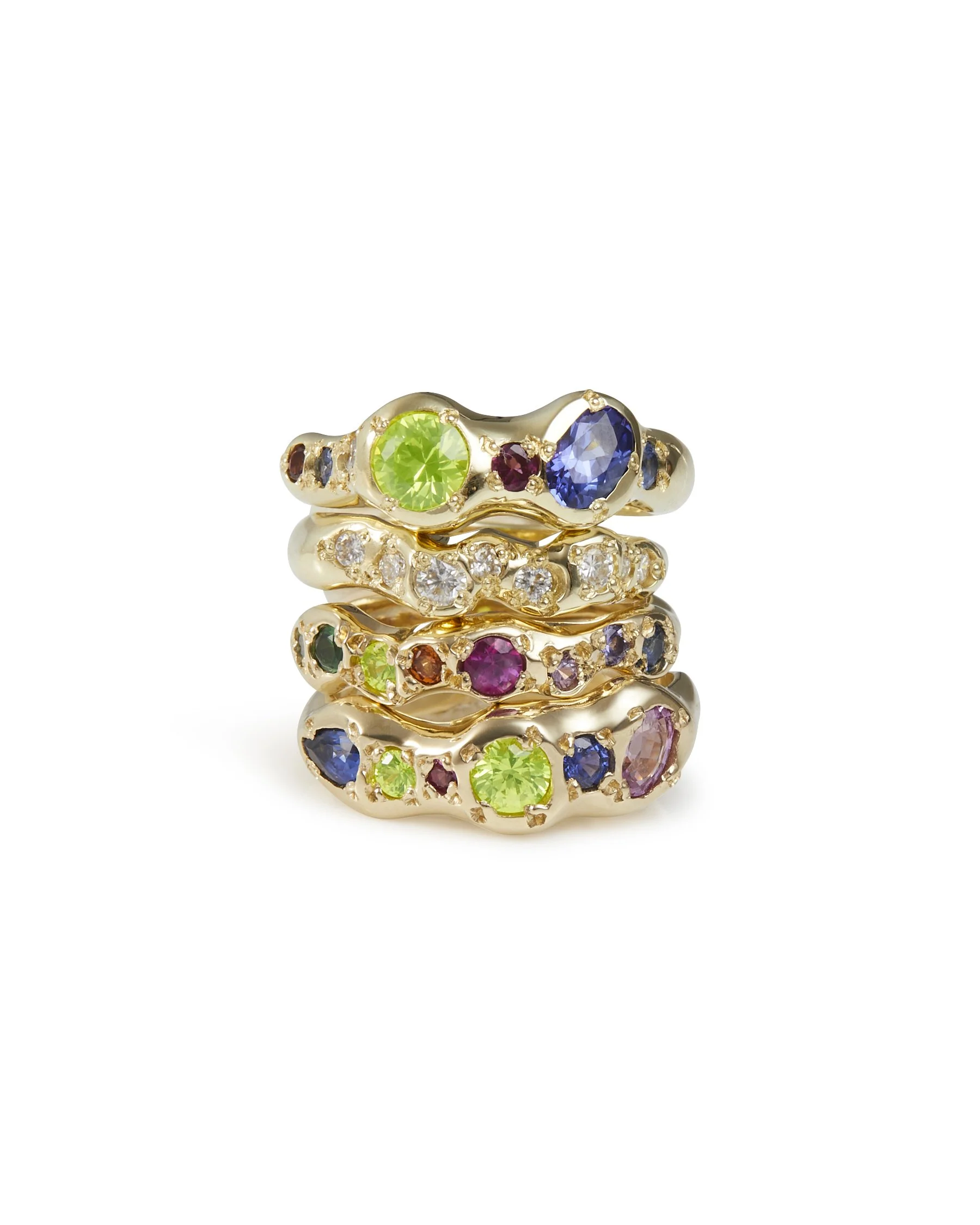 A stack of colourful gold rings on a white background
