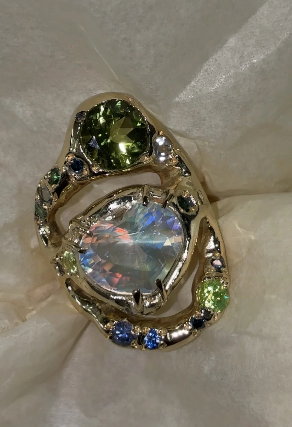 Earth Statement Ring - A 3 strand ring with a central heart moonstone and green and blue gemstones in gold