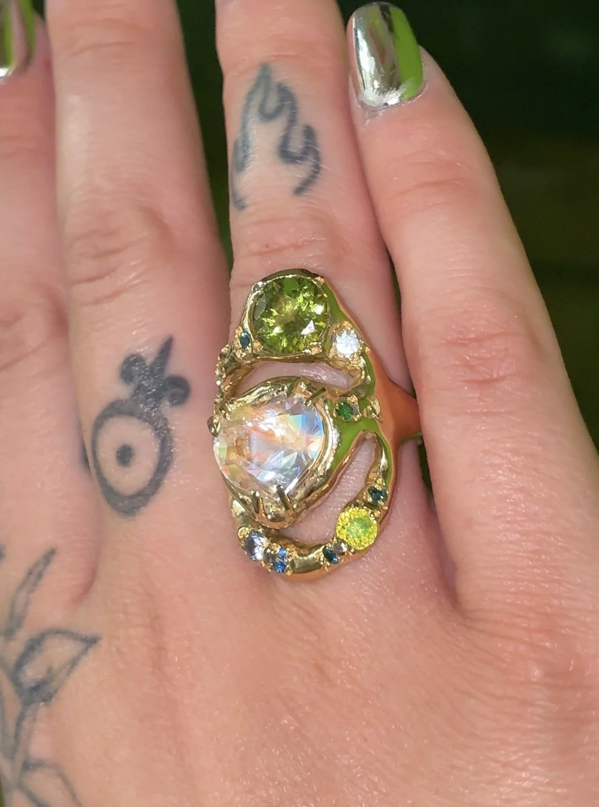 Earth Statement Ring - A 3 strand ring with a central heart moonstone and green and blue gemstones in gold