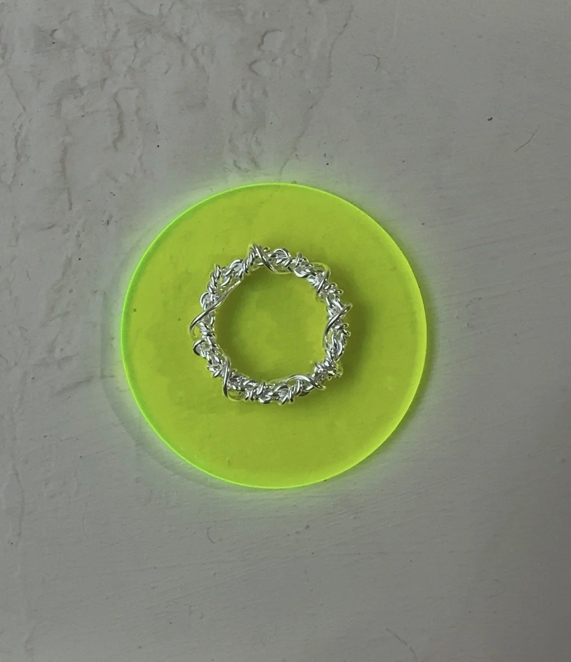rope ring laid on a piece of neon acrylic