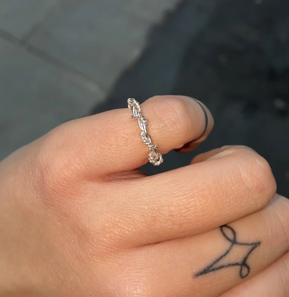 rope ring on pinky finger