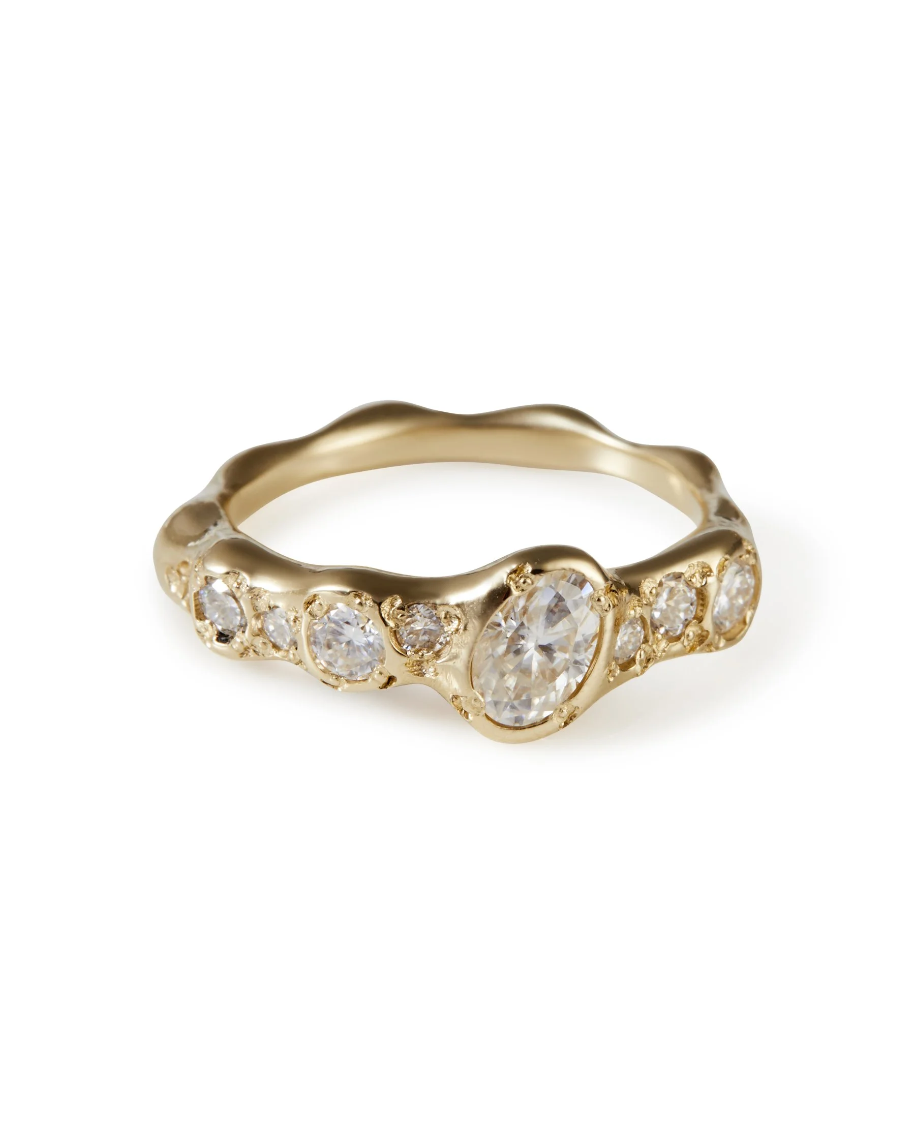 A yellow gold molten ring with moissanites and one central larger tilted moissanite - front view