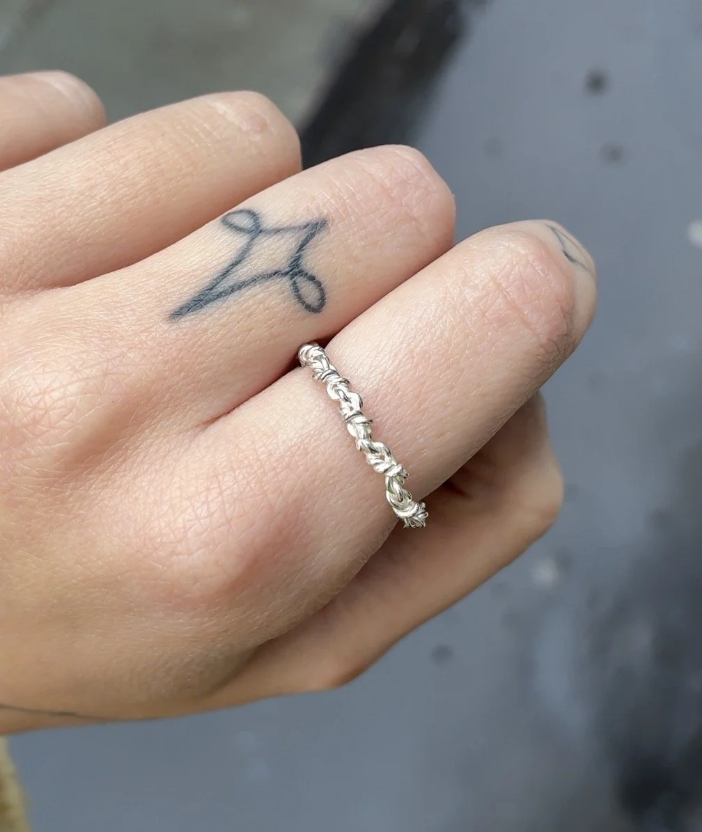 thin rope ring on hand