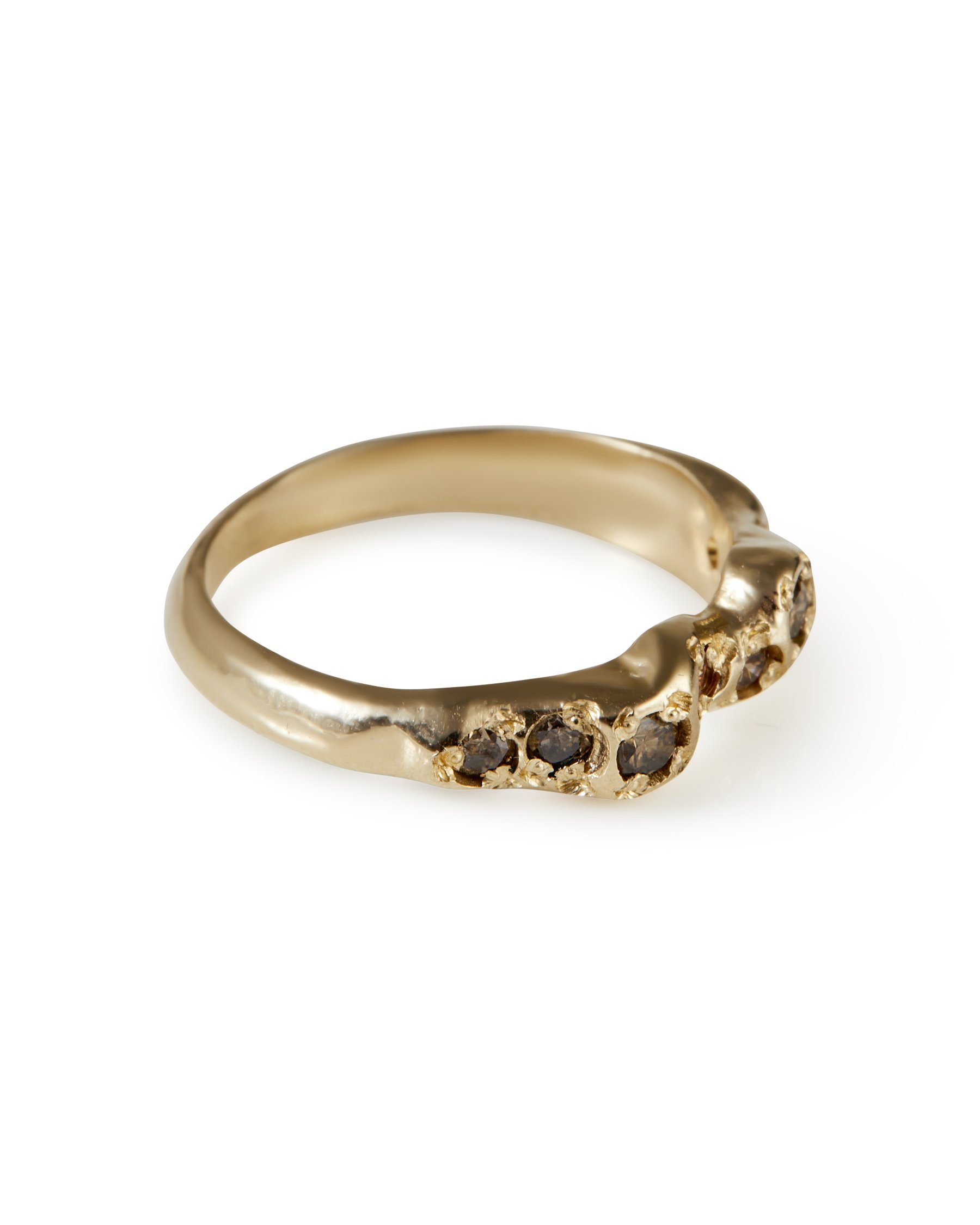 A molten gold ring with a line of blue diamonds set into it - side view