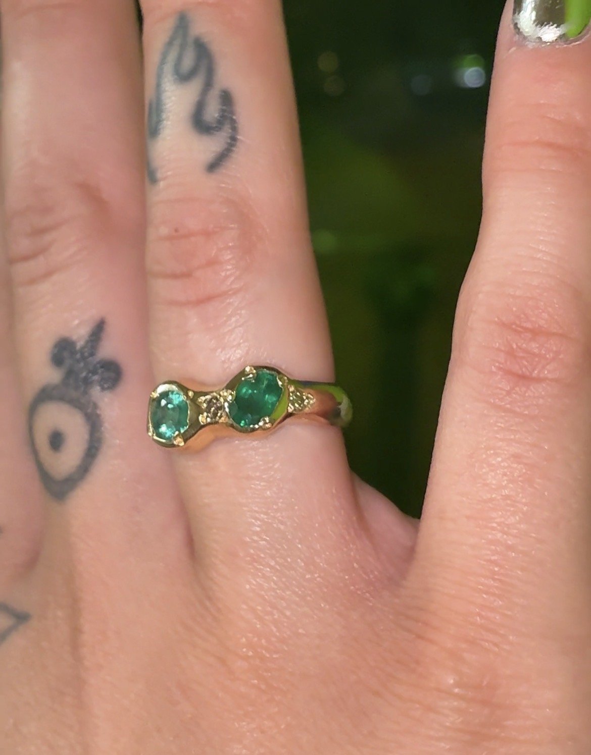 Jupiter Gold Band - a gold band with emeralds and brown diamonds