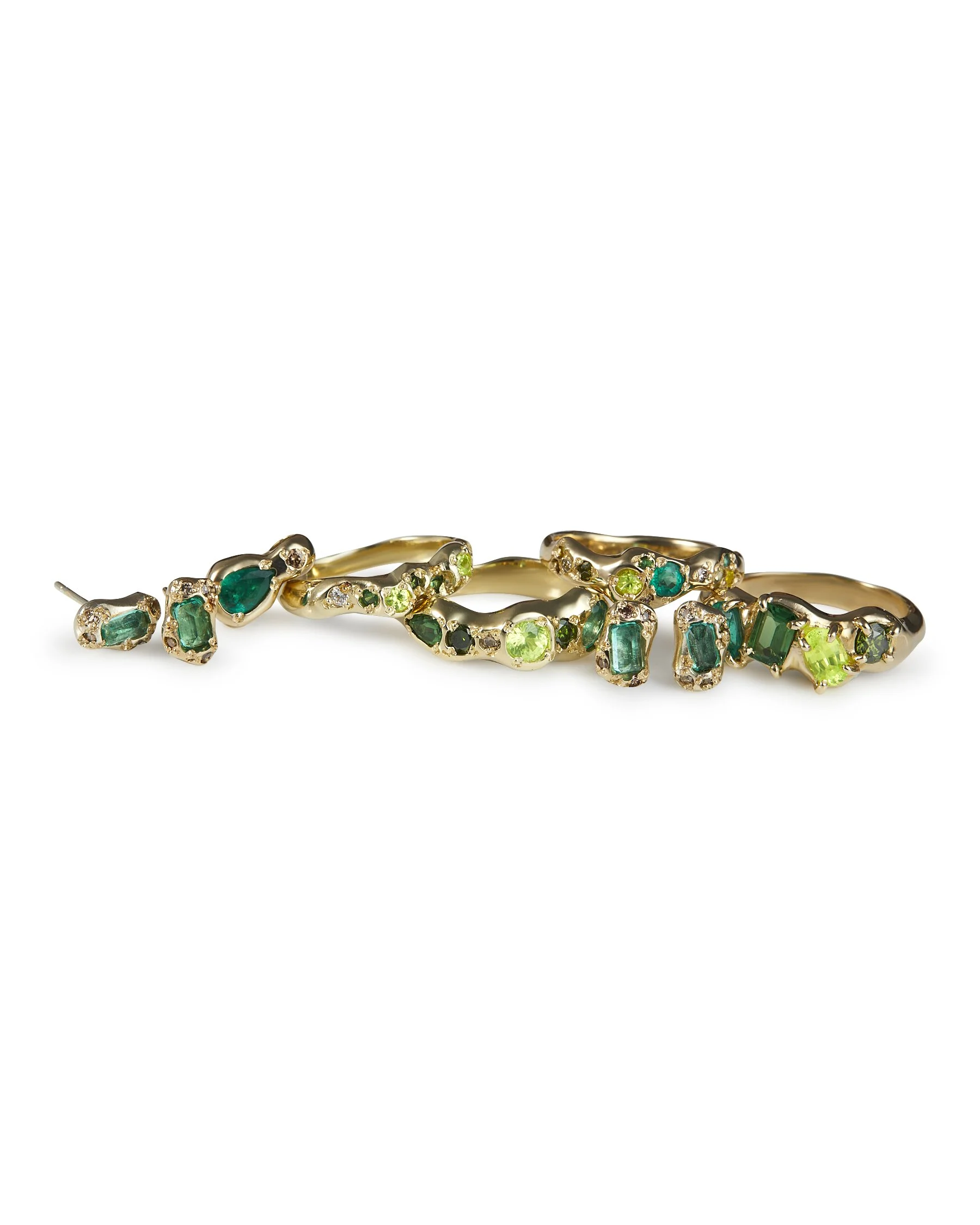 gold bands with green stones on a  white background