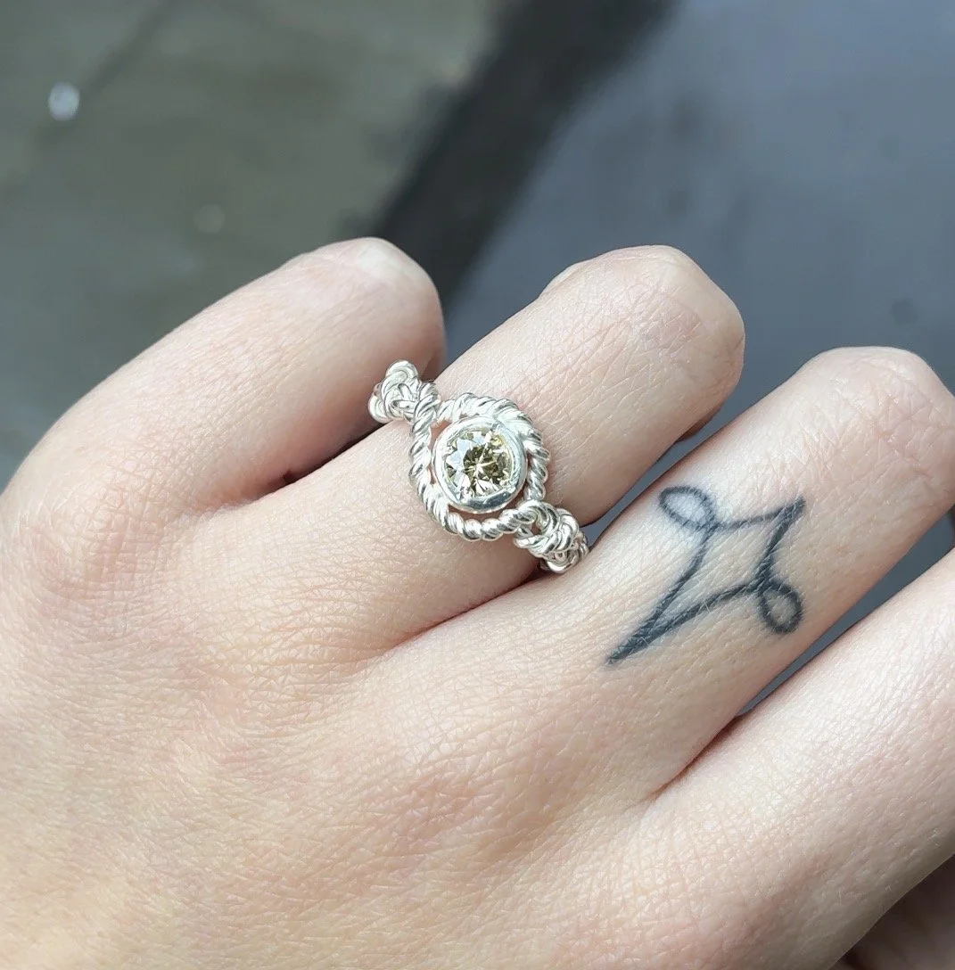 Rope ring with stone on hand