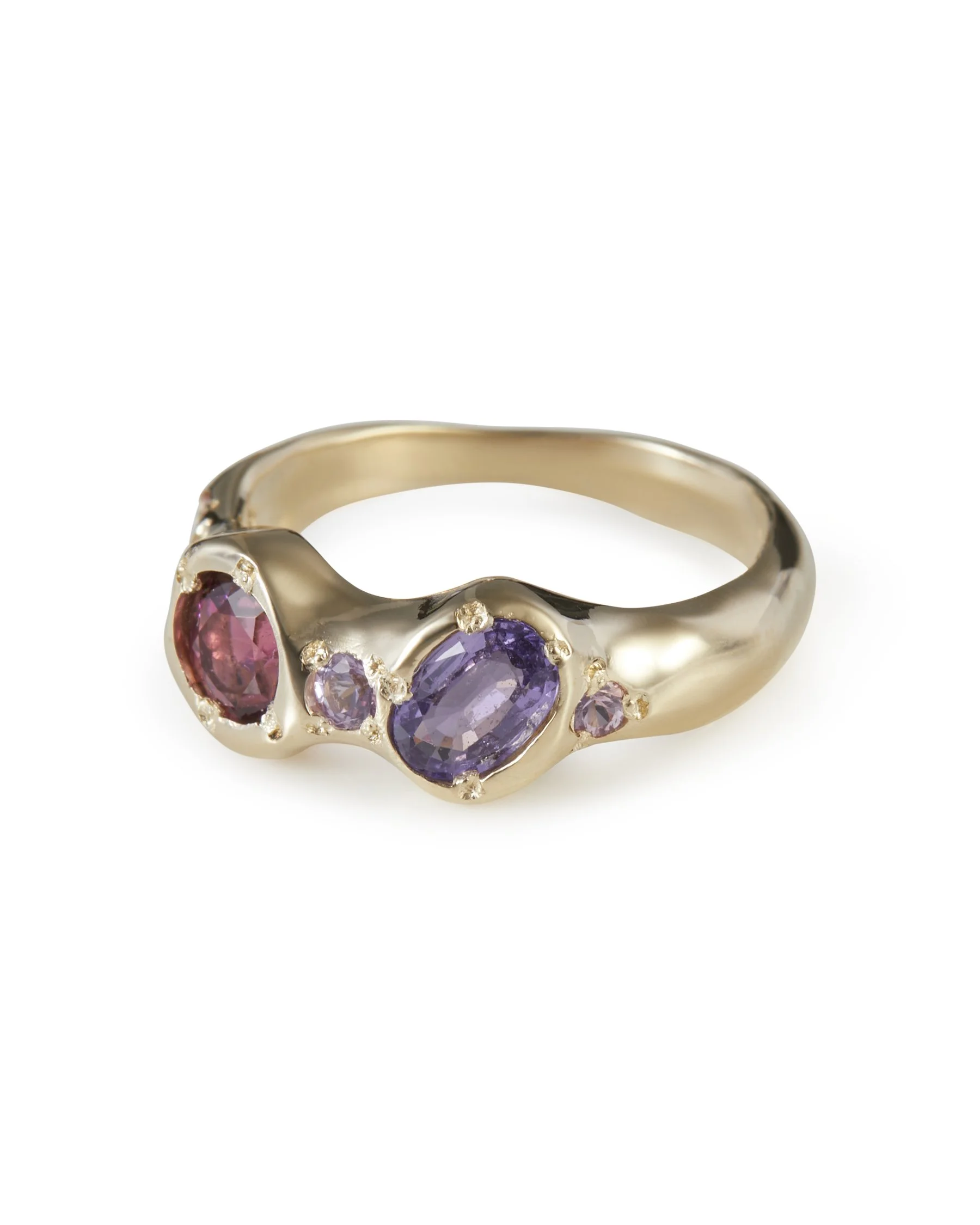 Angled view of the Madeline Alien Eyes Ring featuring pink and purple gemstones in 9ct yellow gold.