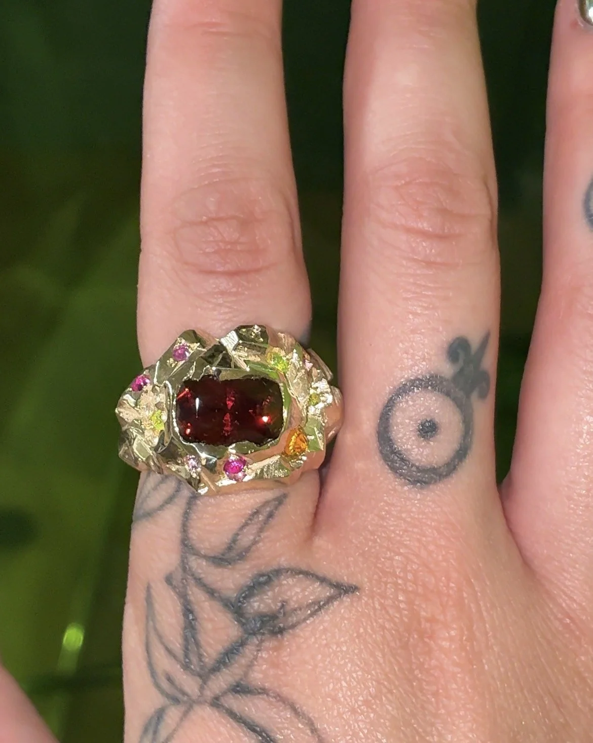 Mars statement ring - a heavily textured ring with garnet, sapphire and luag