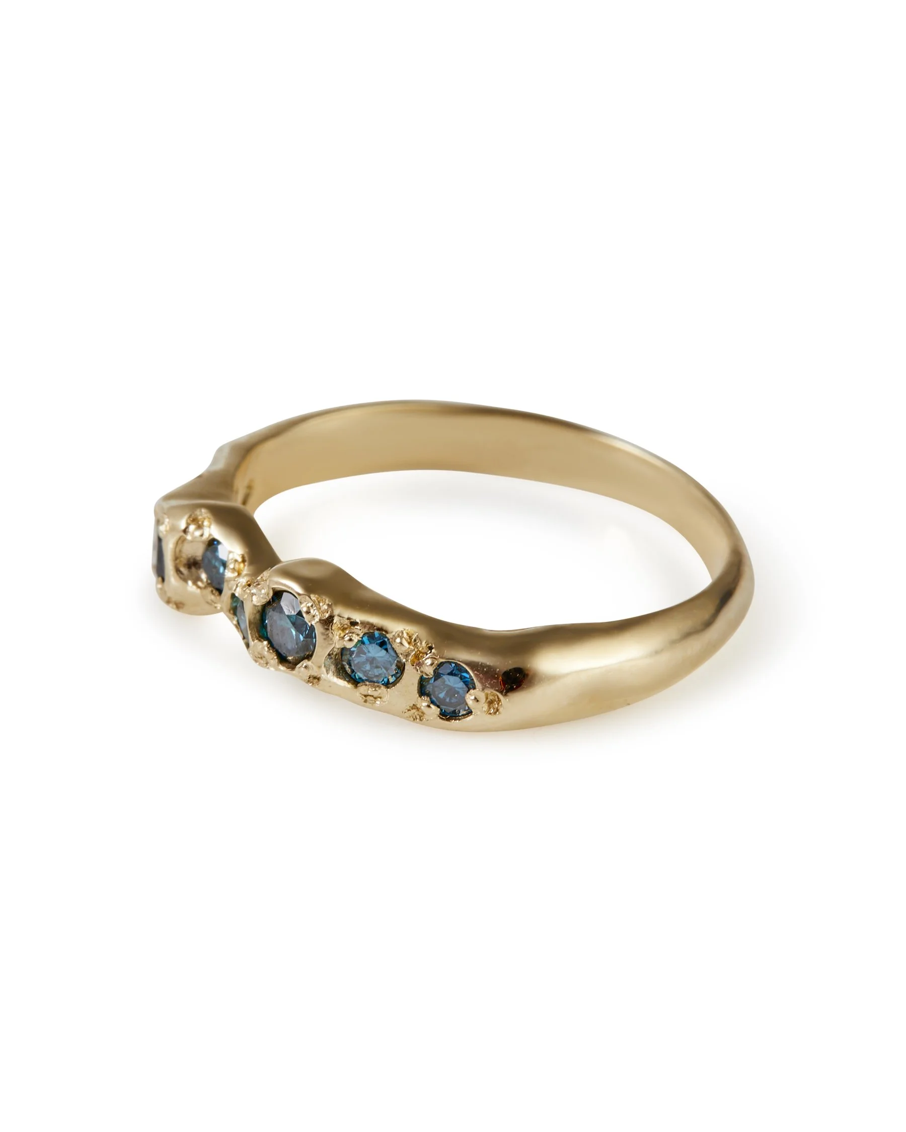 A molten gold ring with a line of blue diamonds set into it - side view