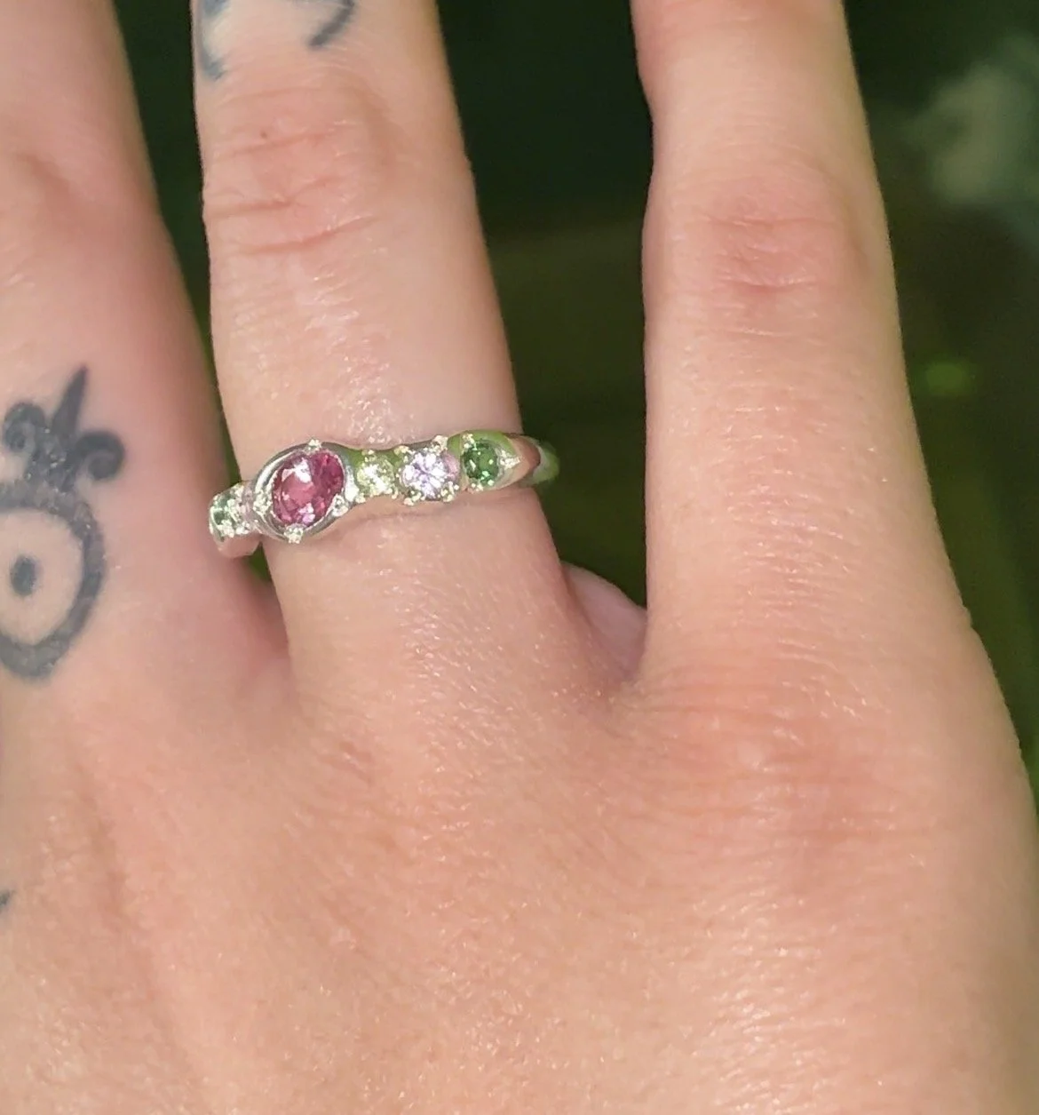 Venus silver band - a silver molten band with pink and green stones inspired by venus