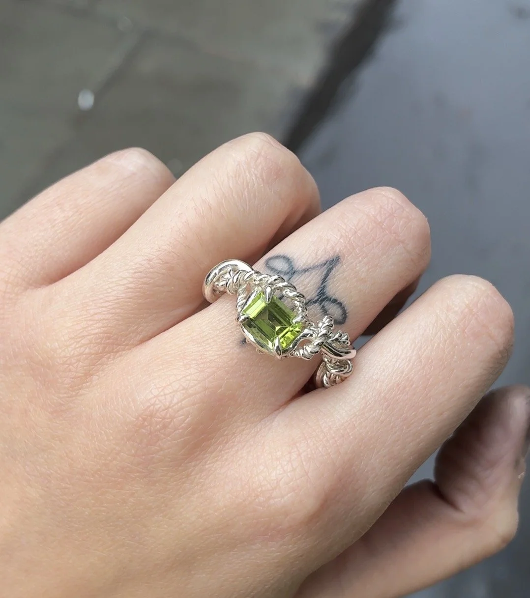 rope ring with peridot on hand