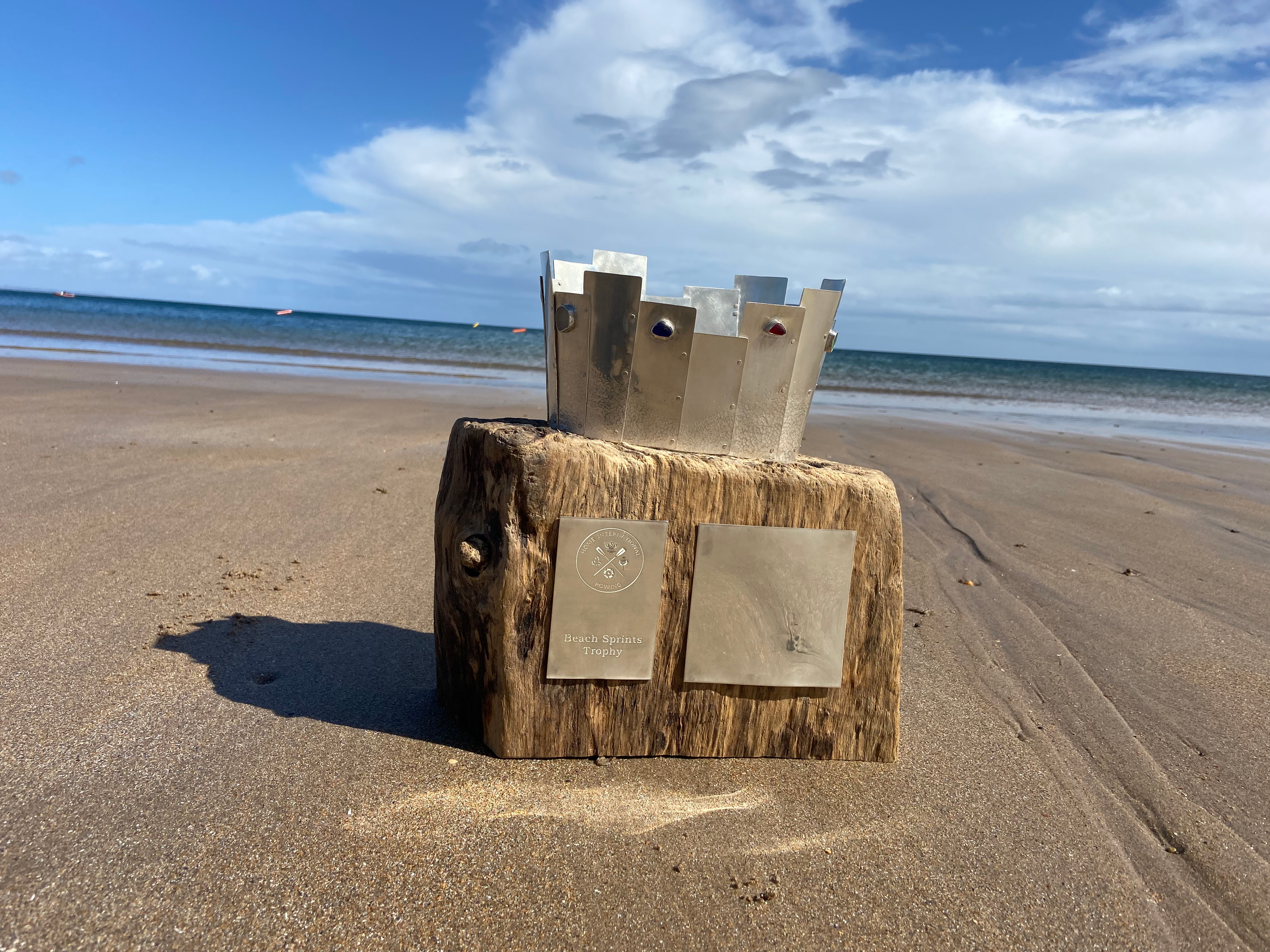 Photo of the HIR Beach Sprints trophy on a beach.