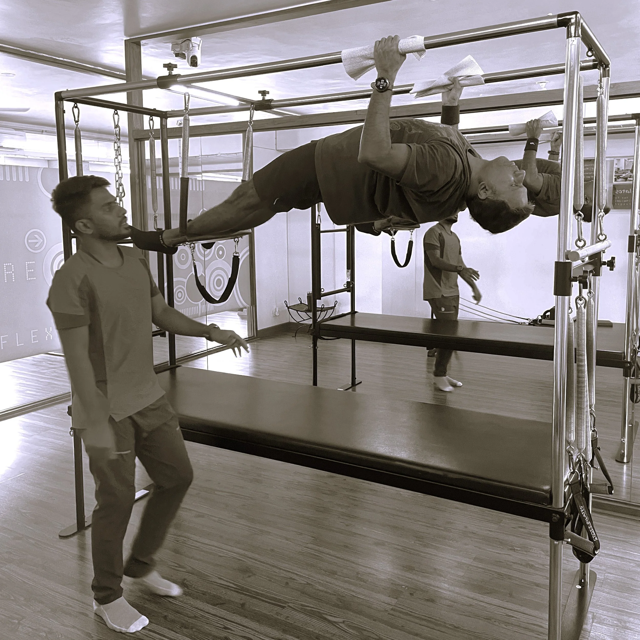 Client on Cadillac doing a pull up in a personal training session