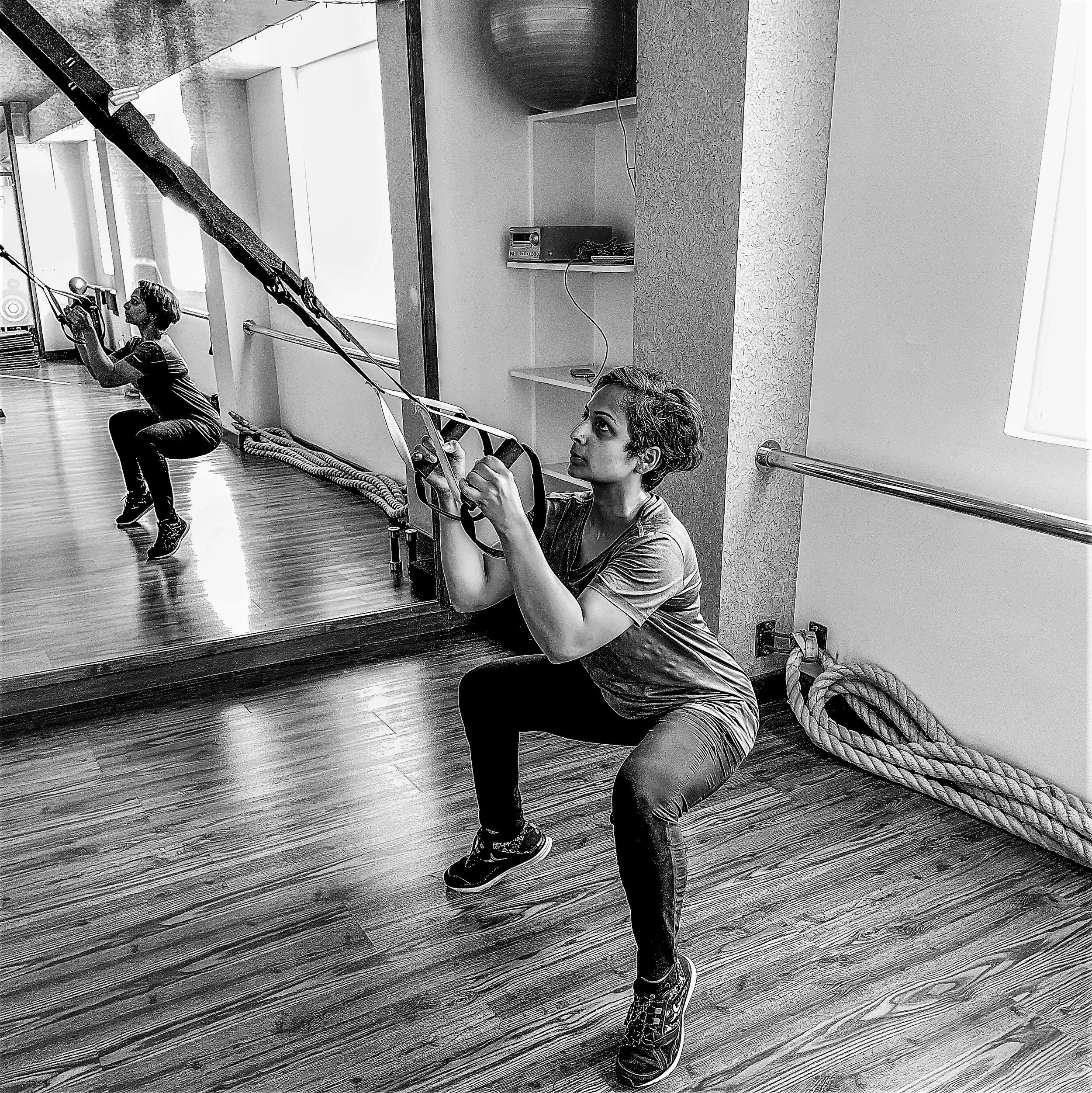 Squats with TRX suspension straps, one-on-one training at The Zone Bangalore