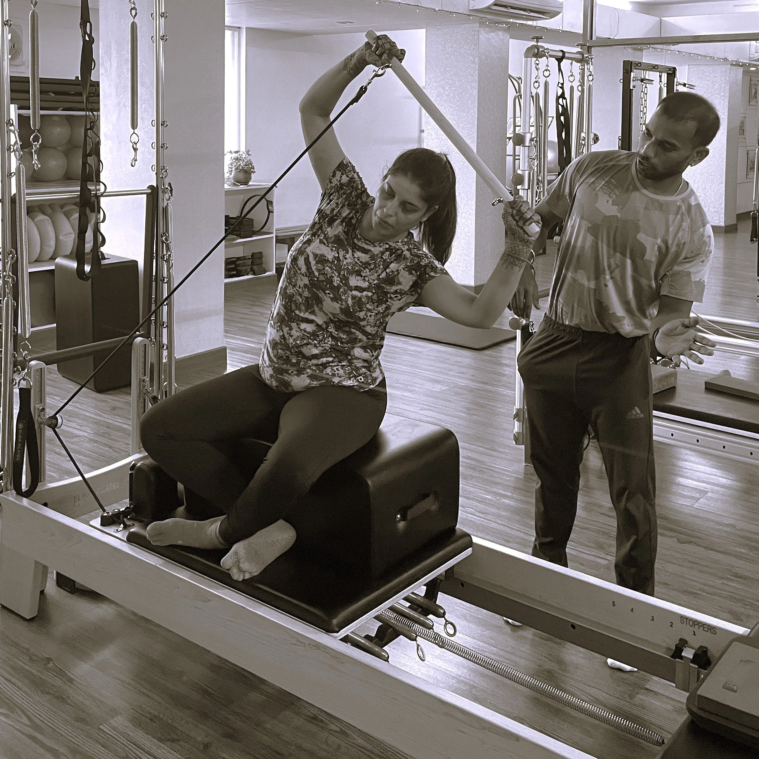 Female client in Pilates personal training session on reformer