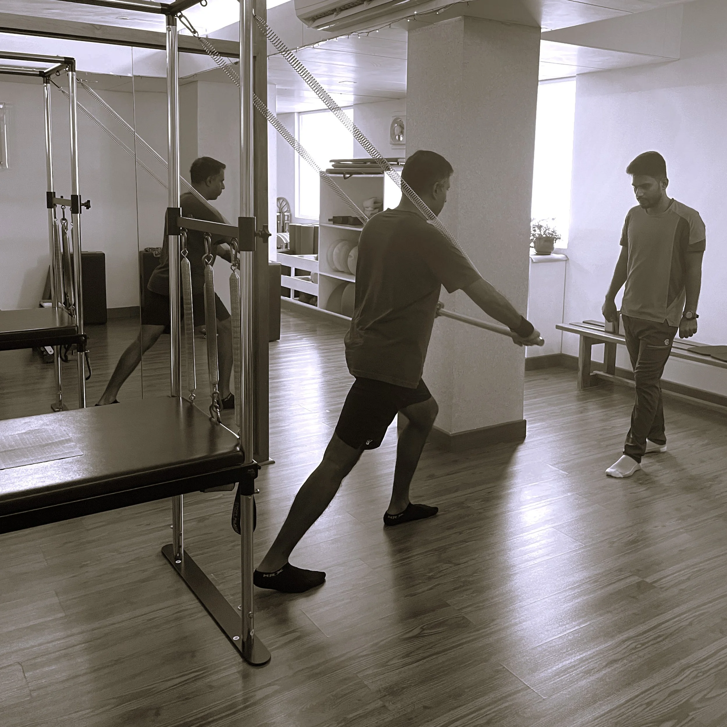 Man doing Pilates personal training on the Tower