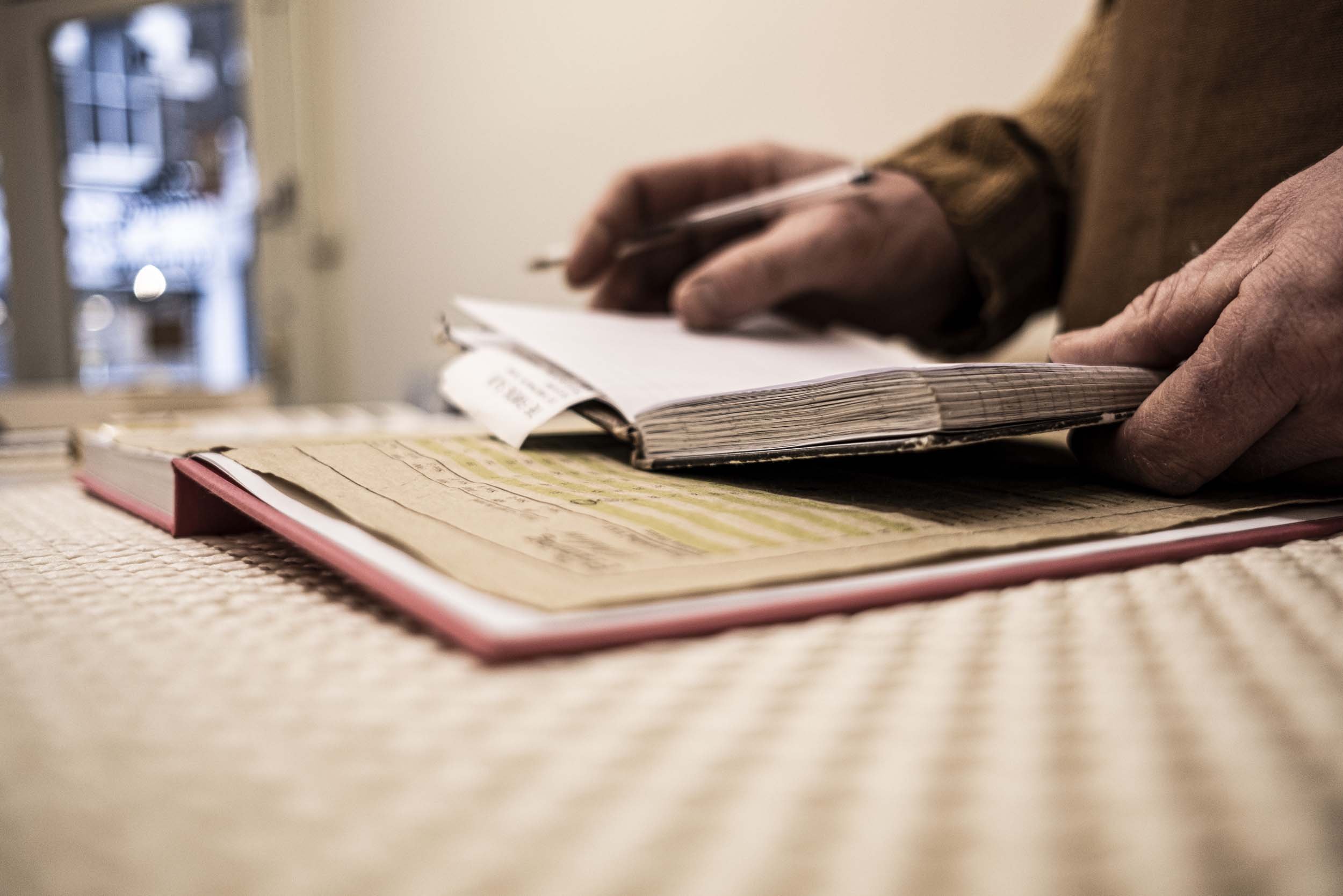 white male hands holding note book.jpg