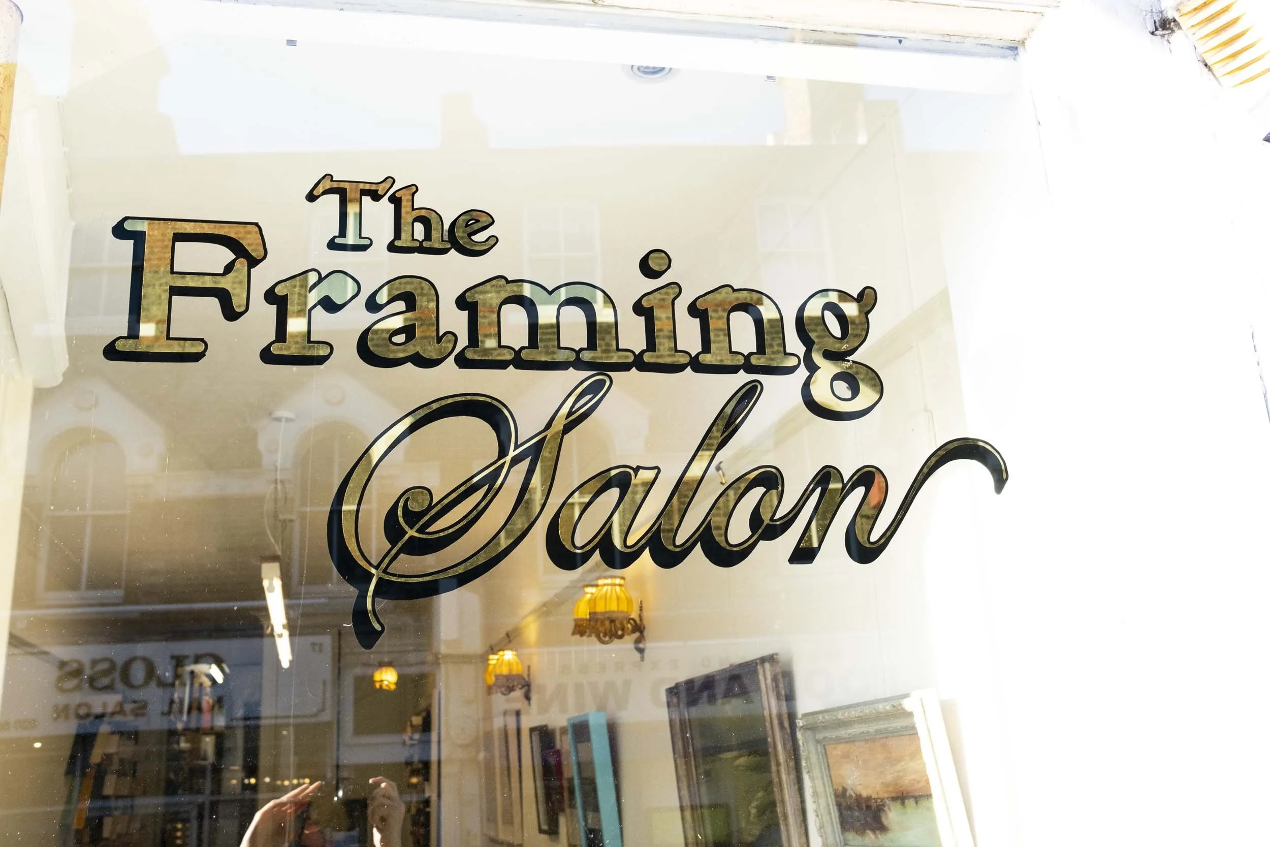 window with metalic shop sign.jpg