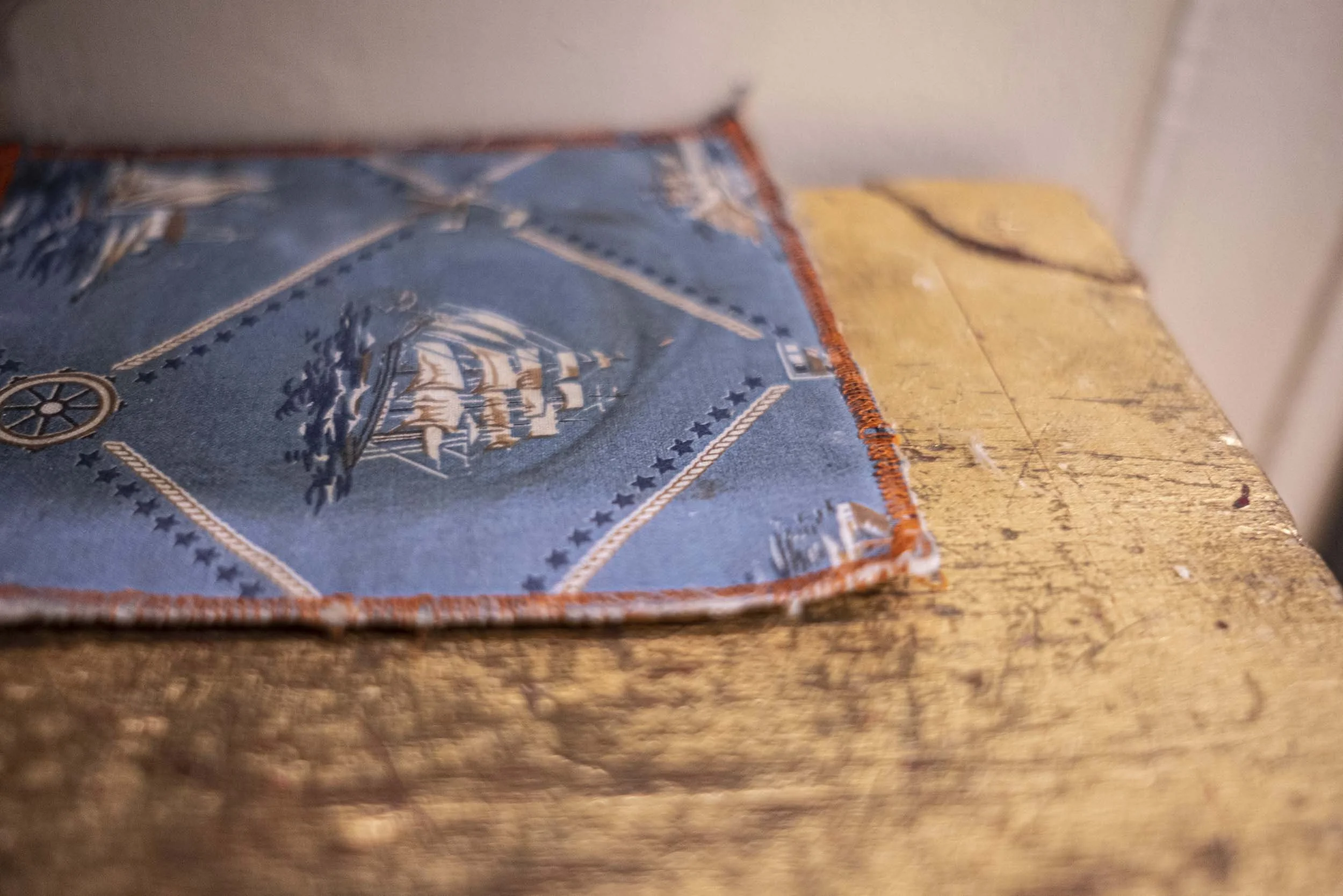 blue fabric printed with ships on wooden chest.jpg