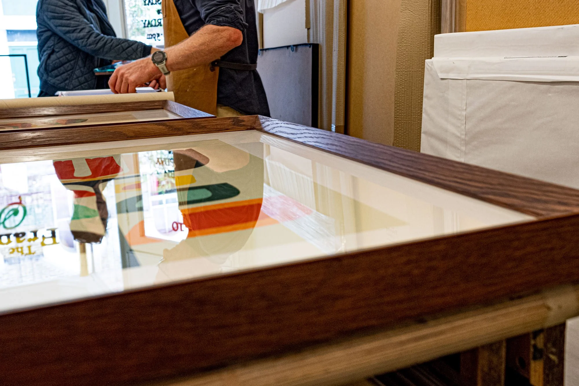 colourful picture in dark wooden frame laying on table.jpg