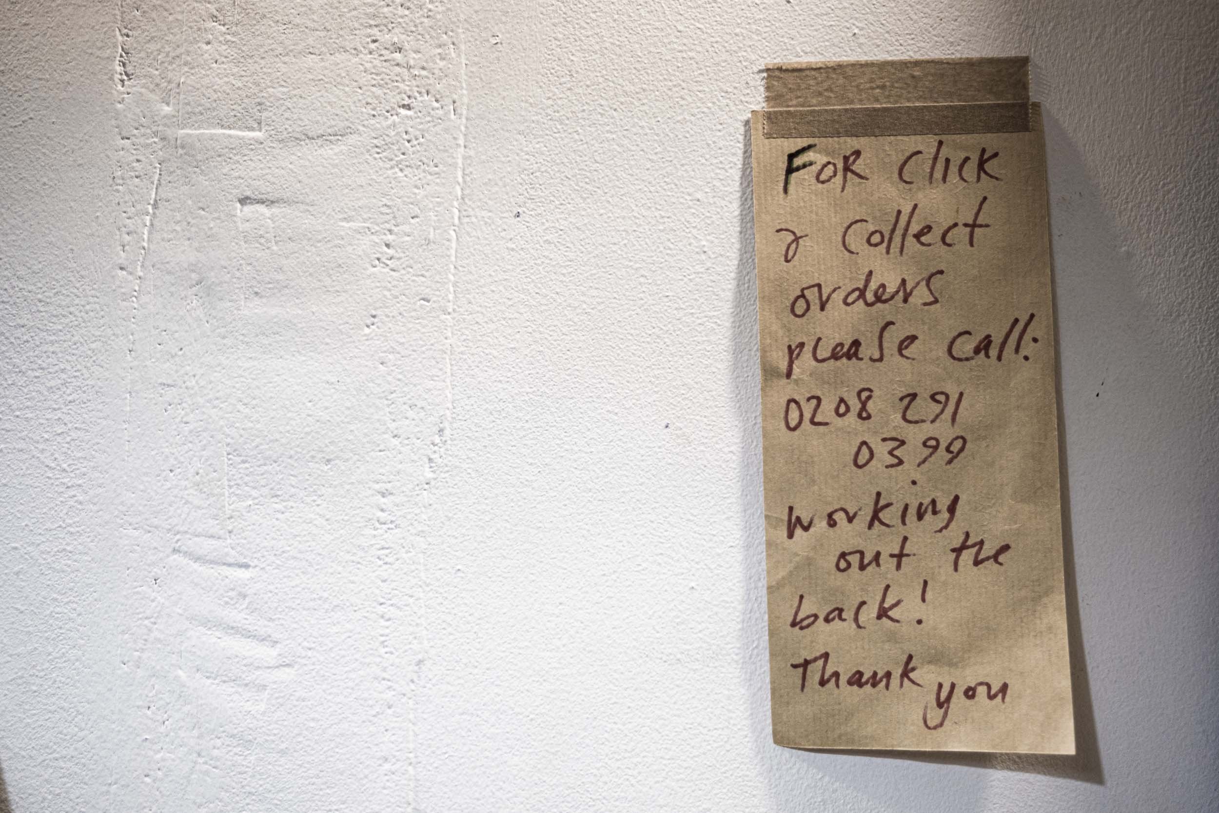 hand written note stuck on wall.jpg
