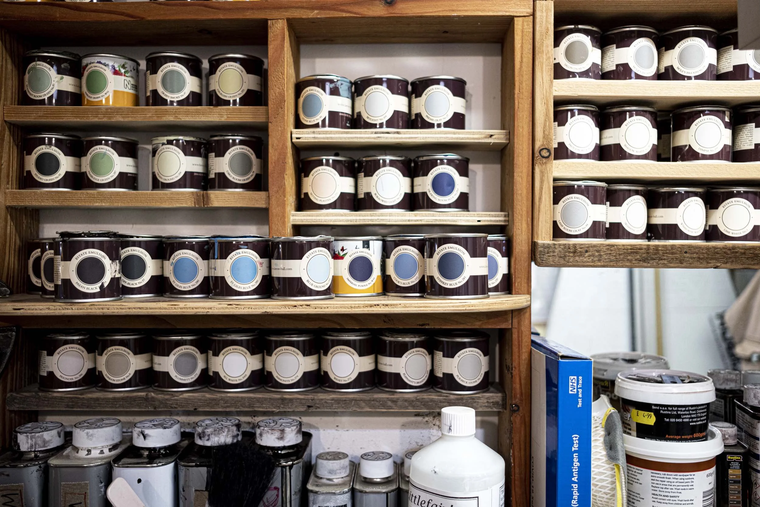 paint tins on wooden shelving.jpg