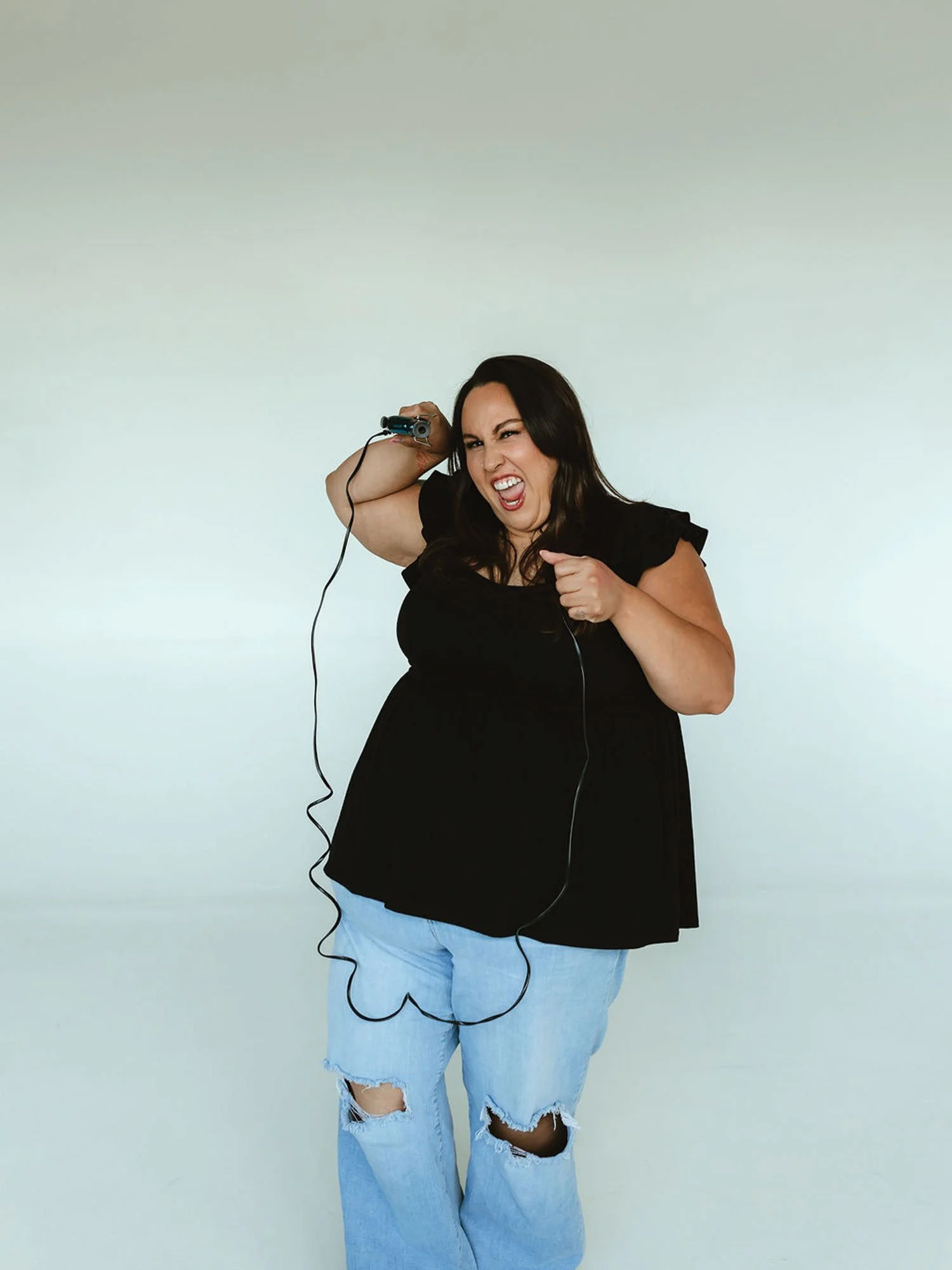 Makeup artist holding brushes in a studio