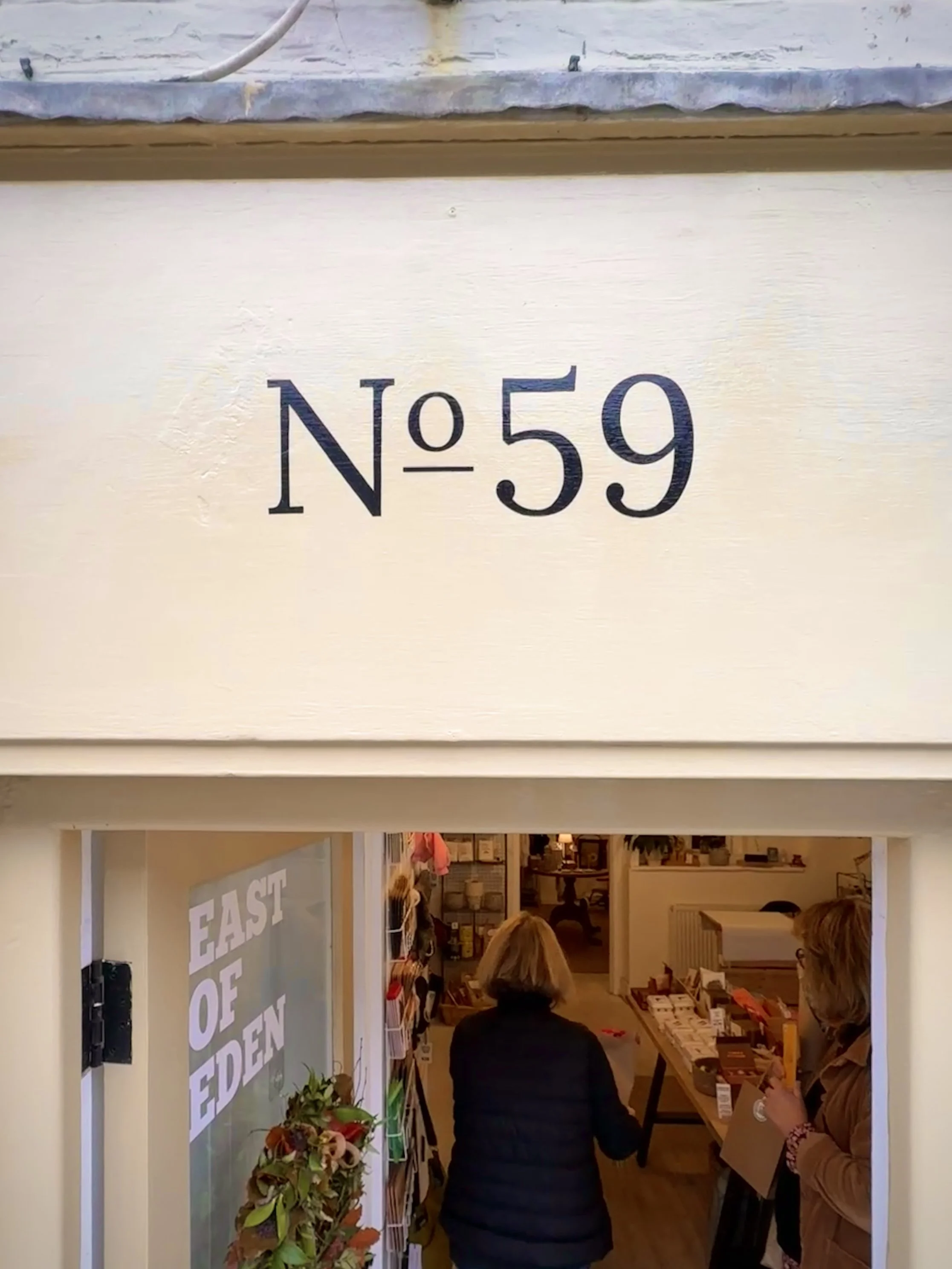 Sign writing logo on shop fascia
 Mobbs & Daughters, Southwold, Suffolk UK 