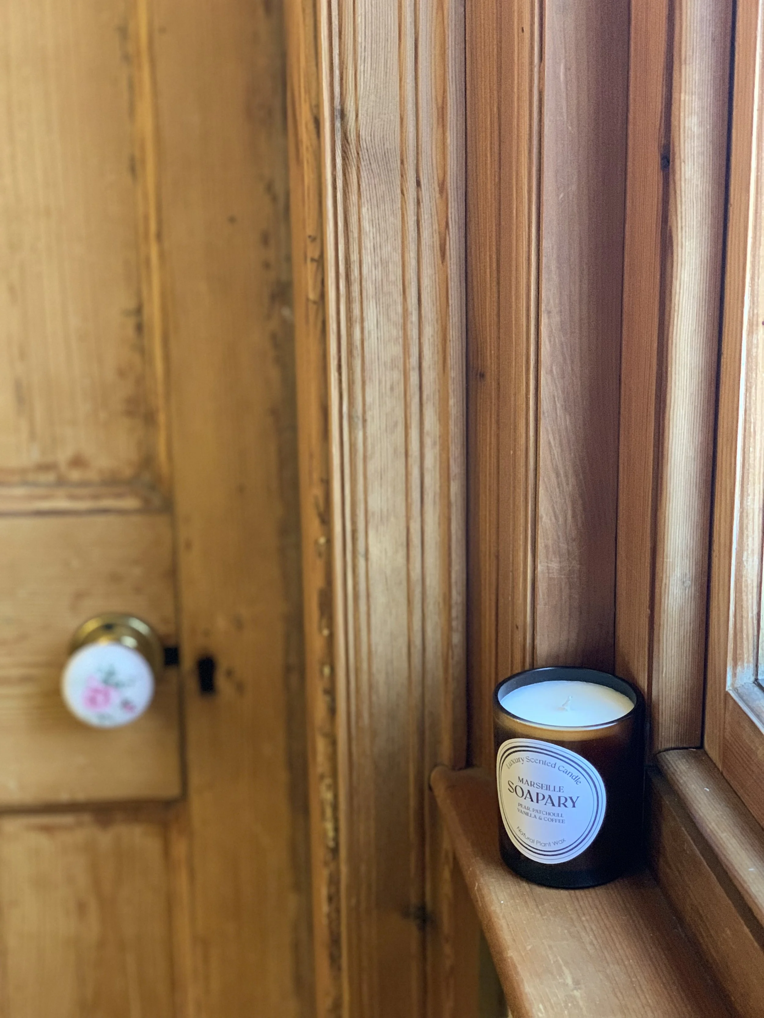 candle positioned a windowsill