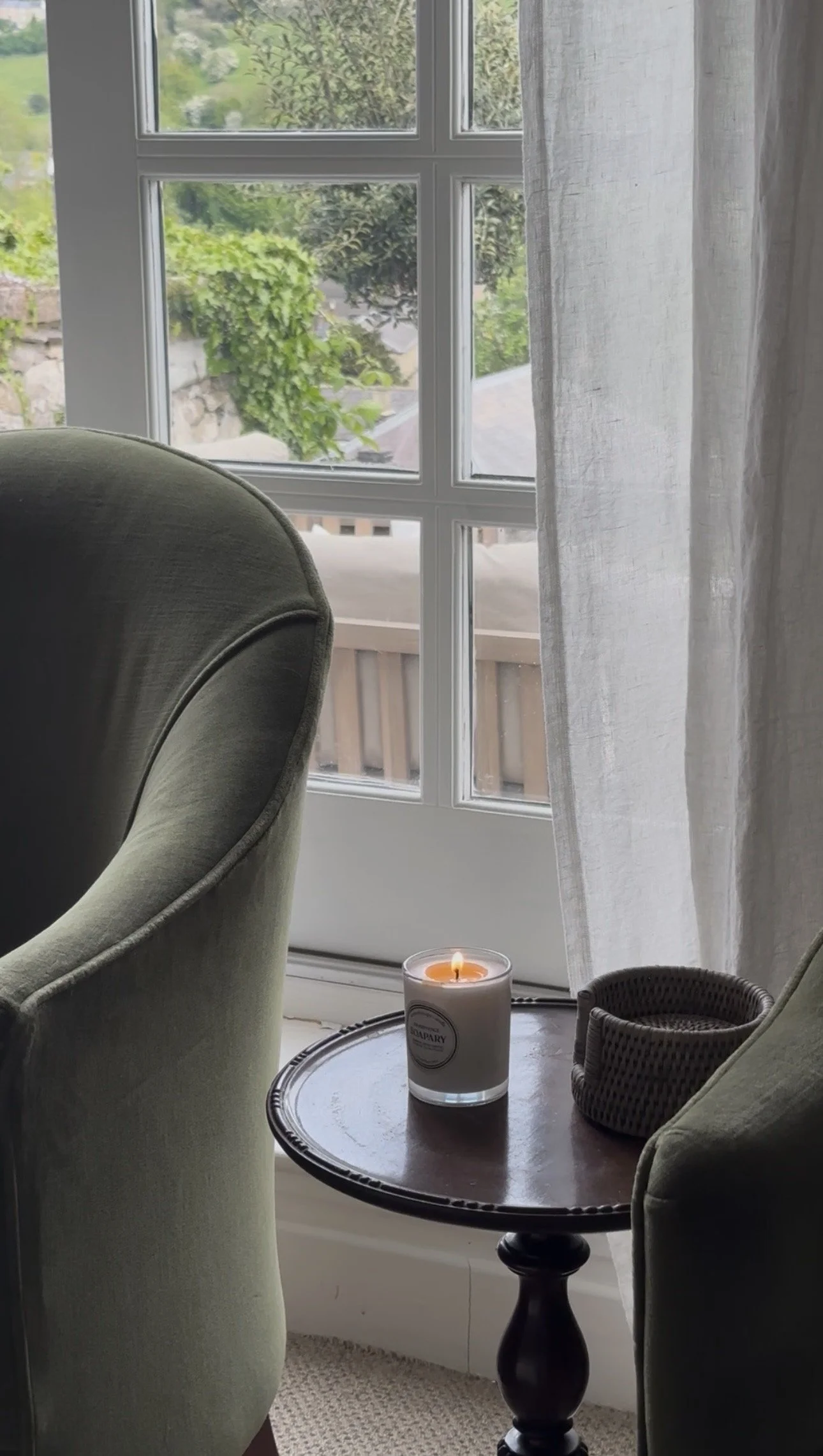 softly lit candle on side table