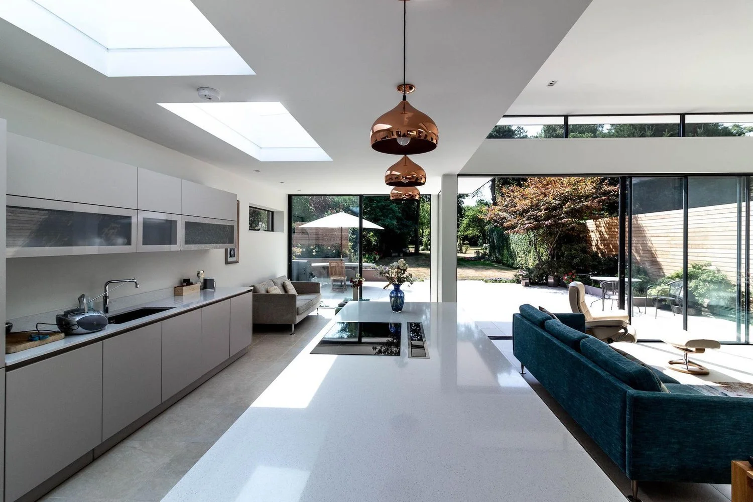 large open plan handleless grey kitchen with bifolds